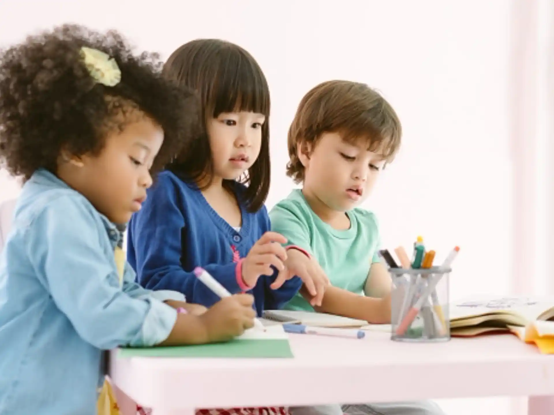 a group of children sitting at a table