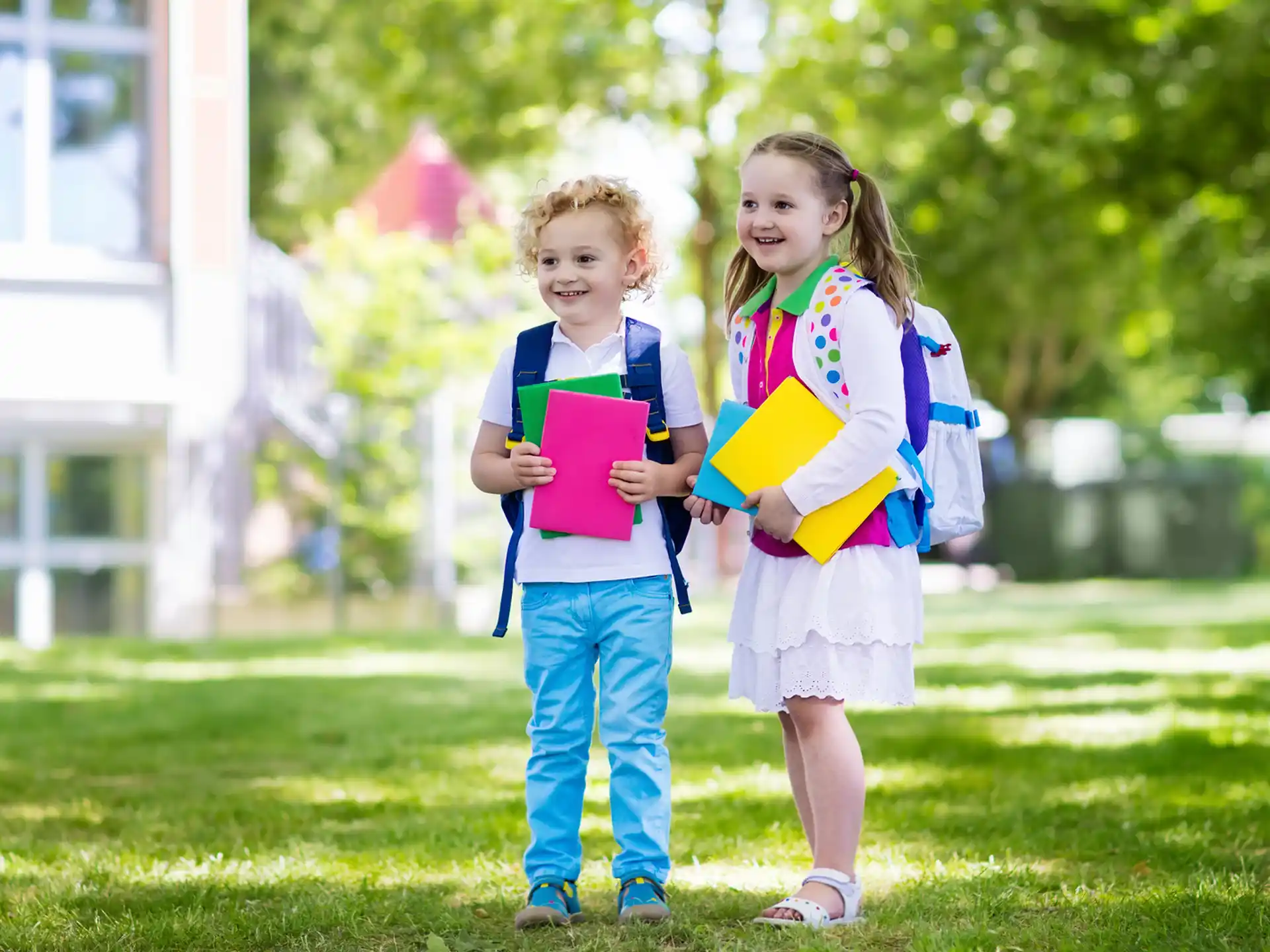 a couple of children holding books