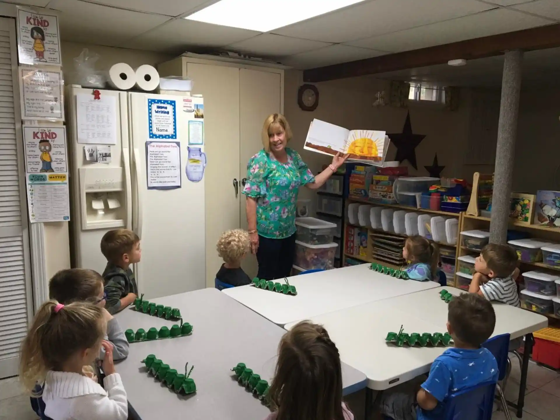a person and children in a classroom