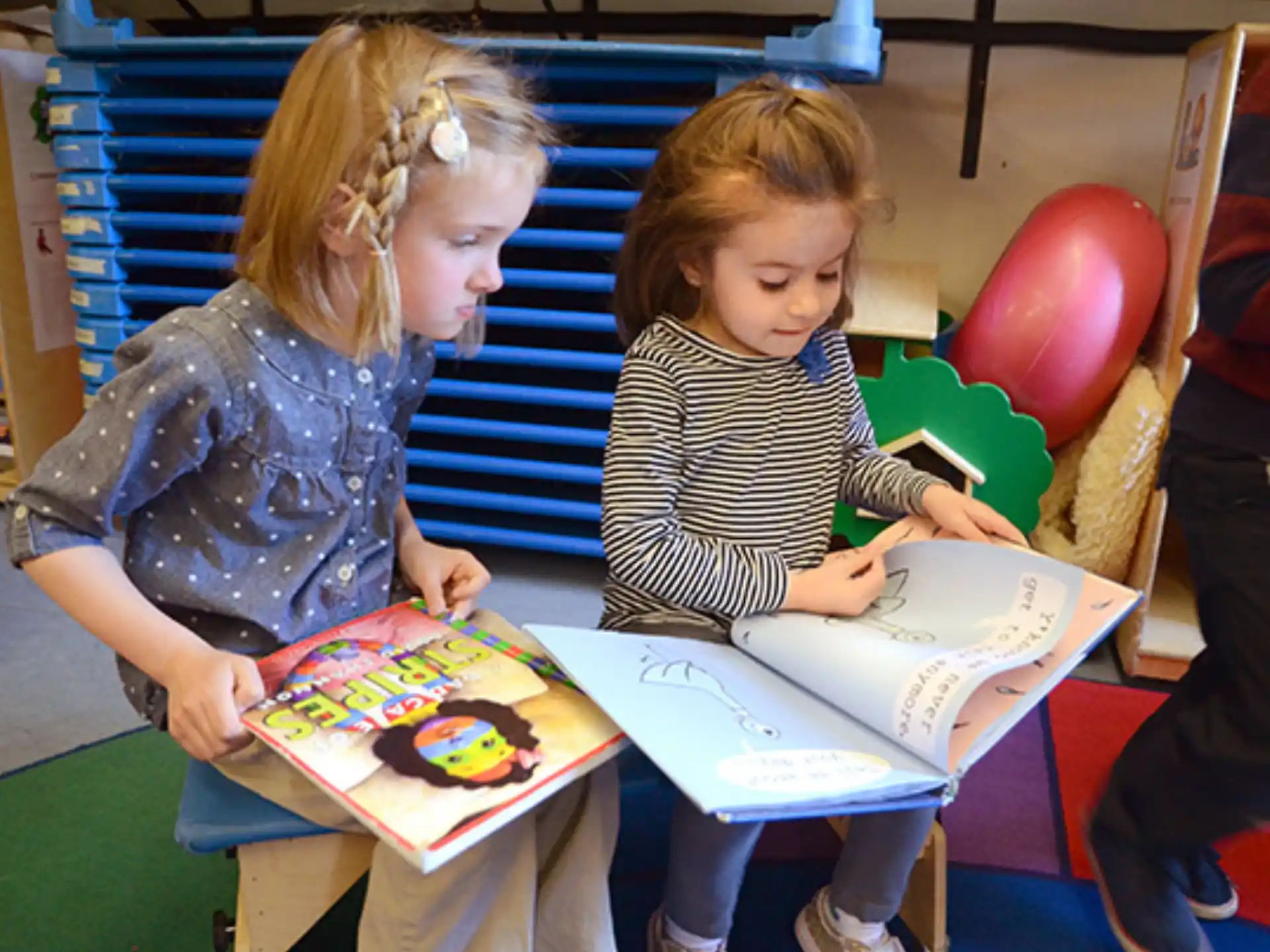 a person and a child reading a book