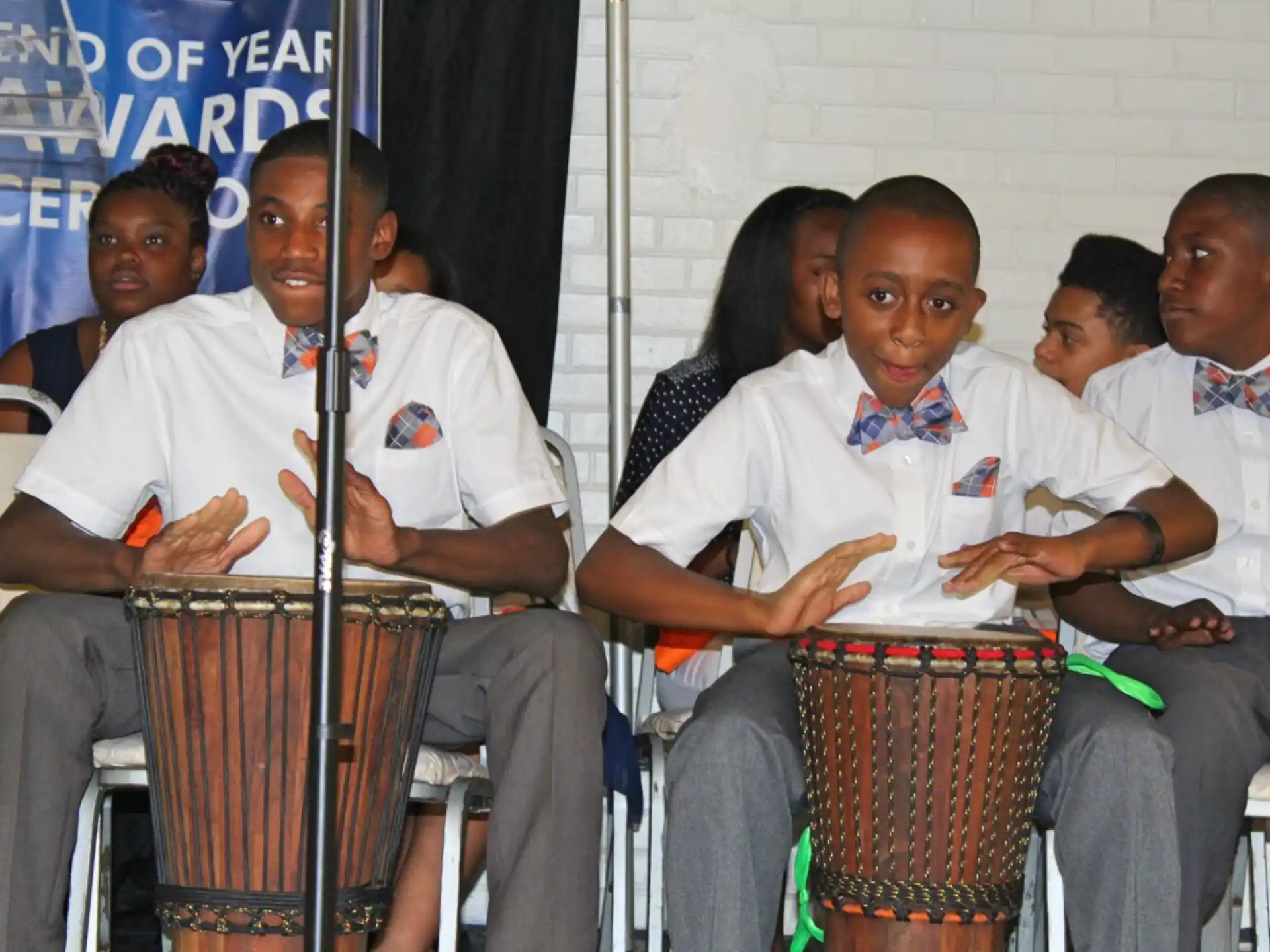 a group of people sitting and playing drums
