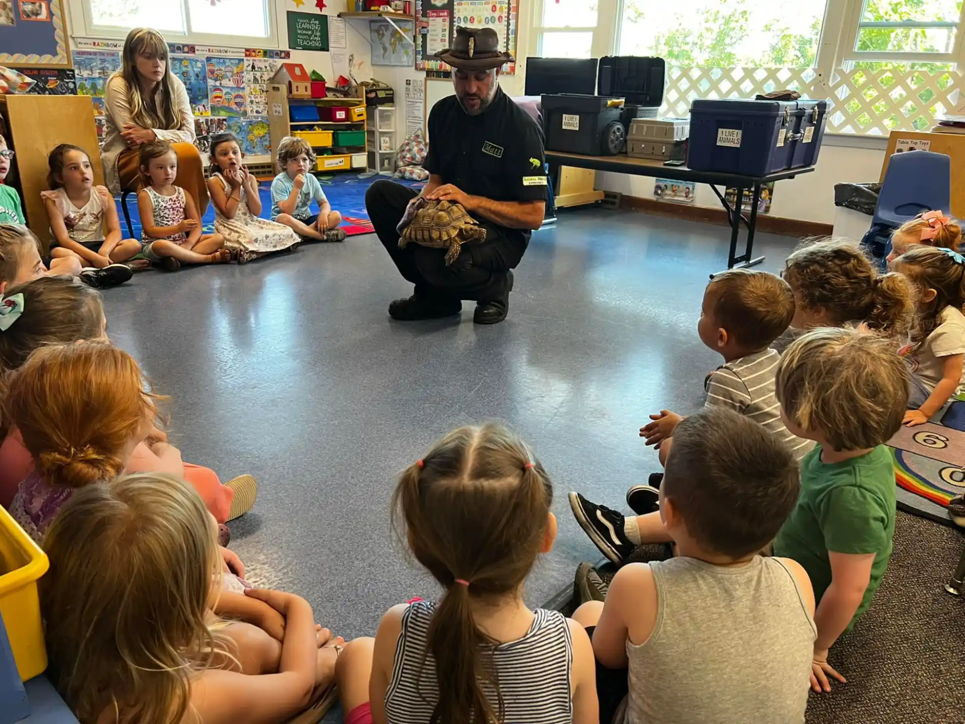 a person sitting in front of a group of children