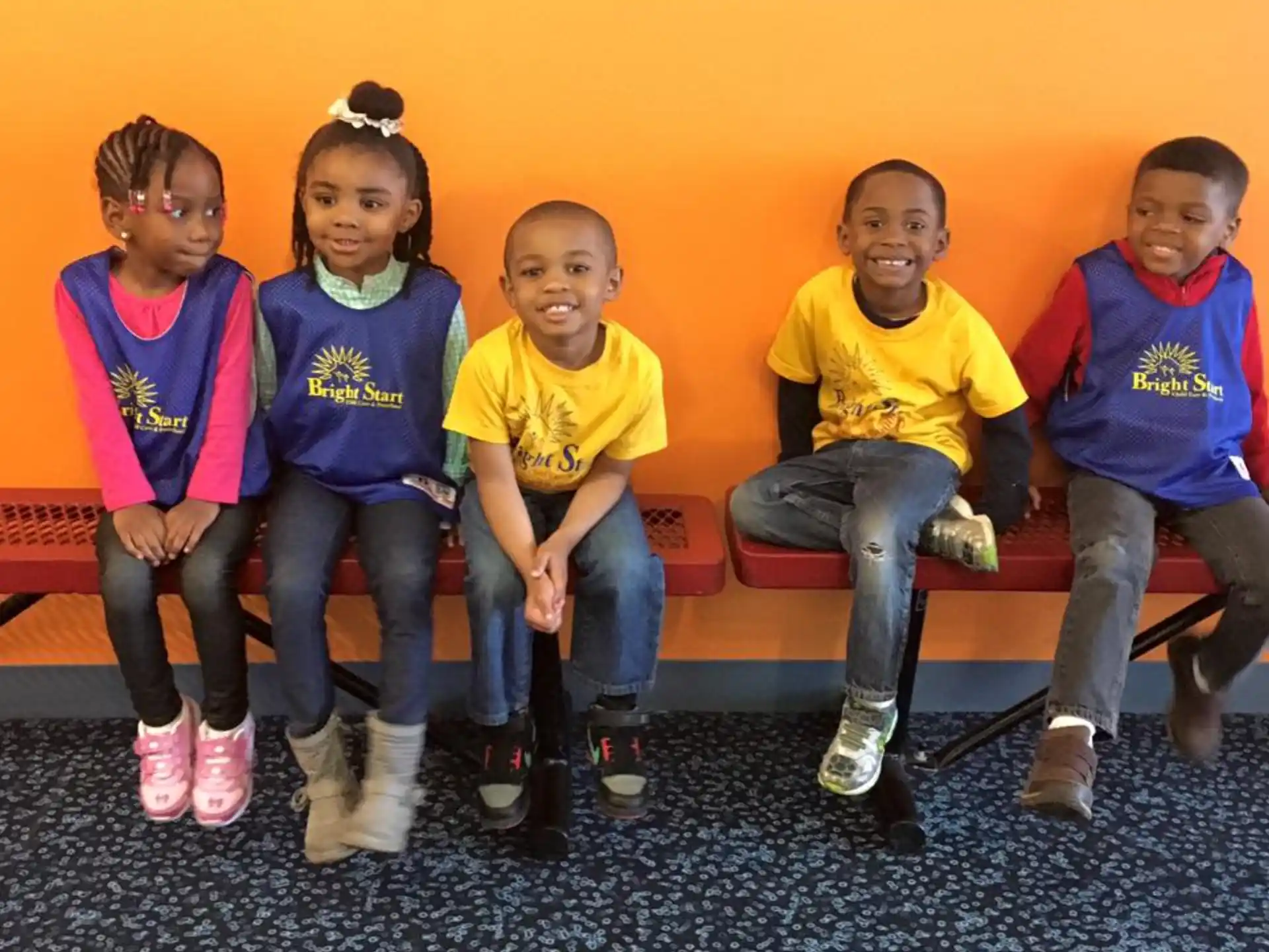 a group of children sitting on a bench