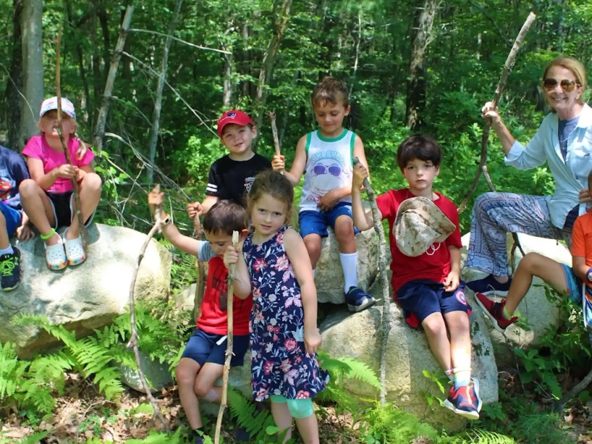 a group of people posing for a photo in the woods