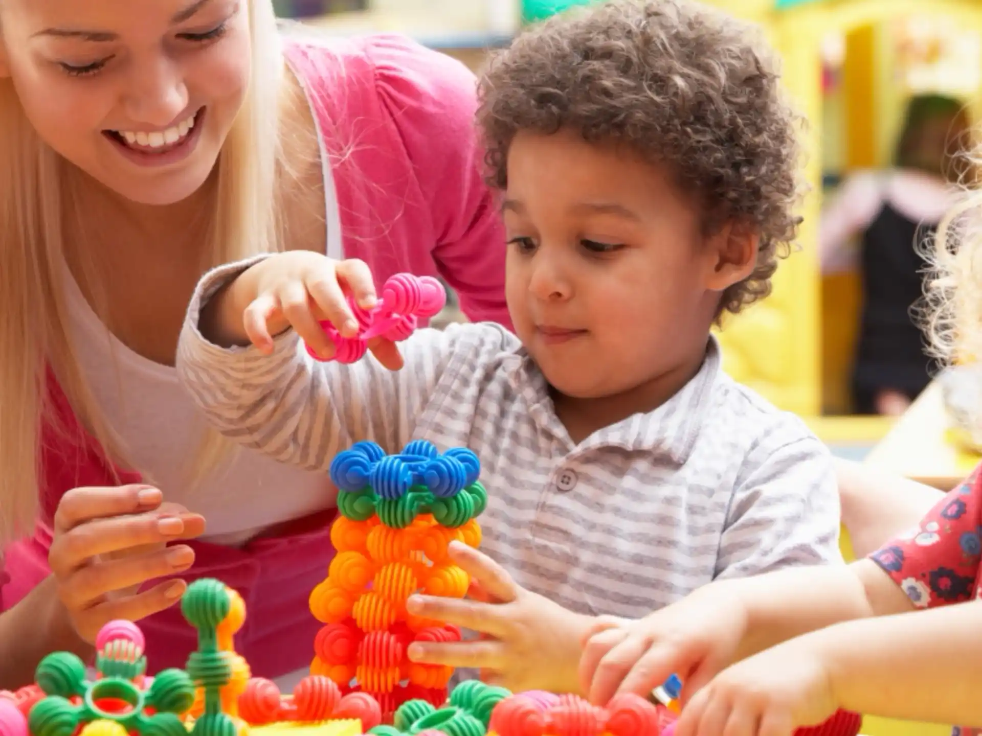 a person and a child playing with toys