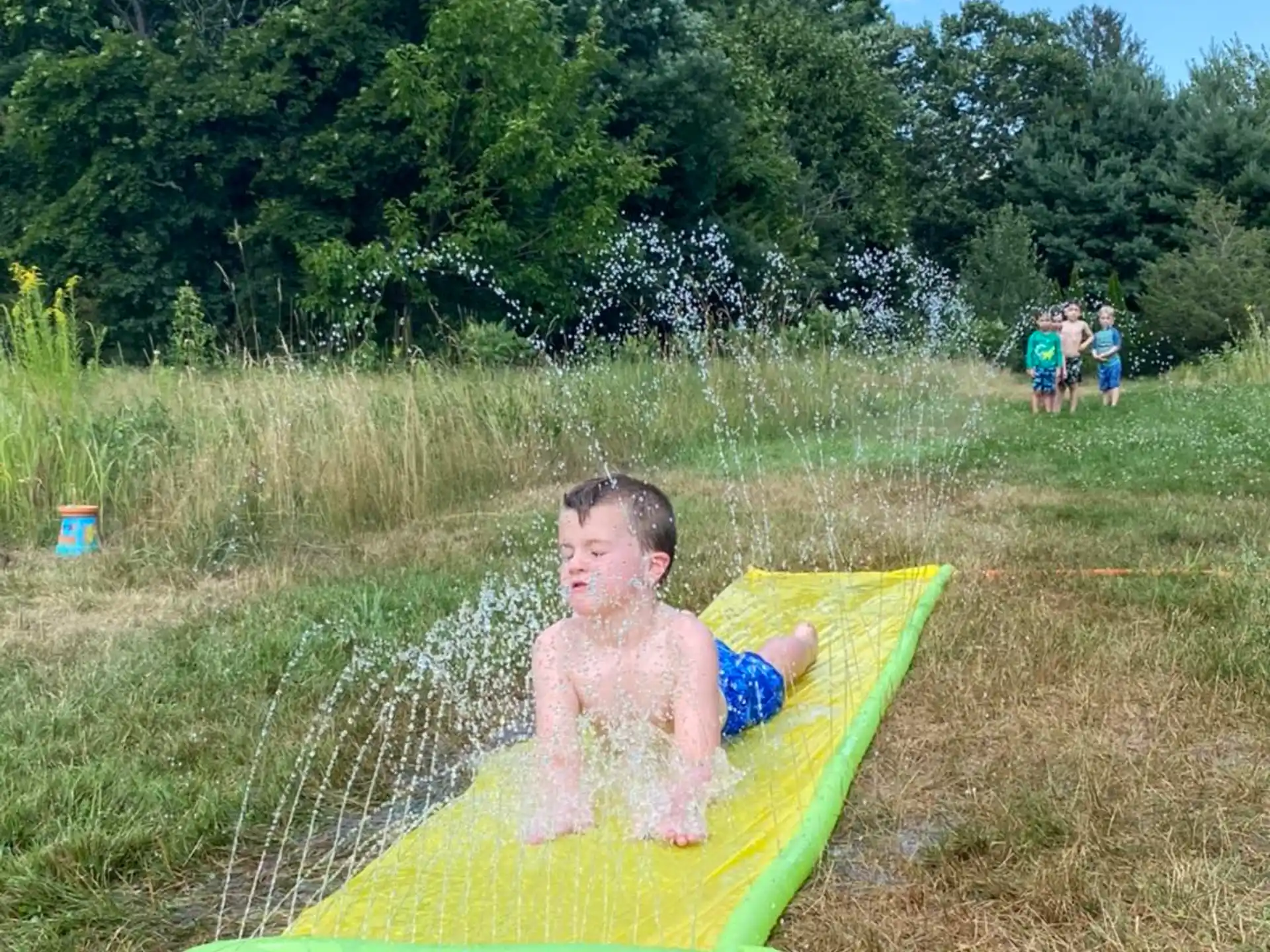 a boy sitting on a pool