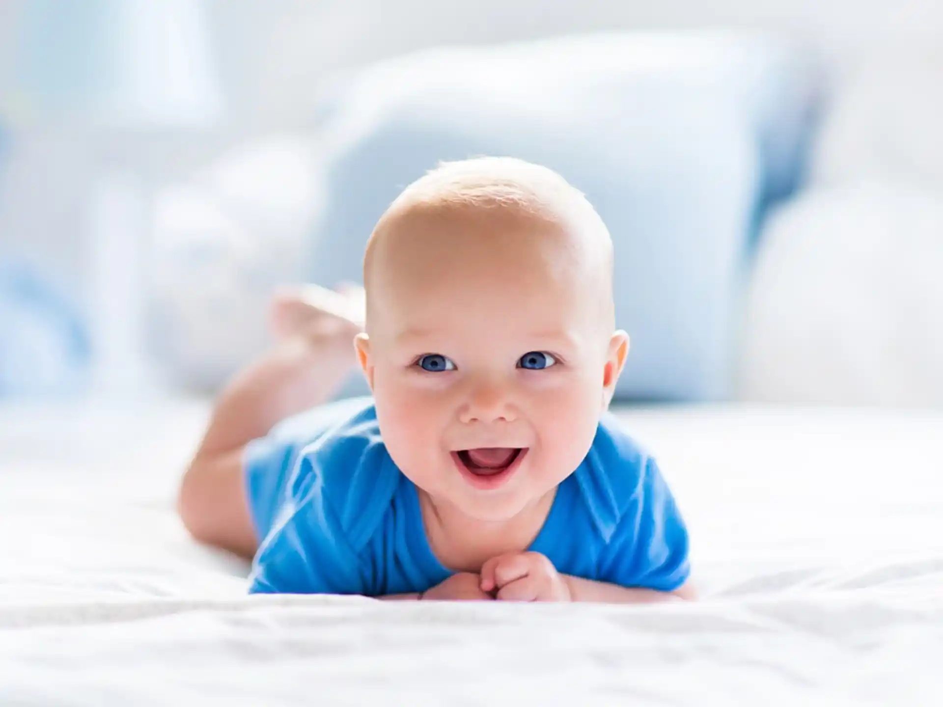 a baby lying on a bed