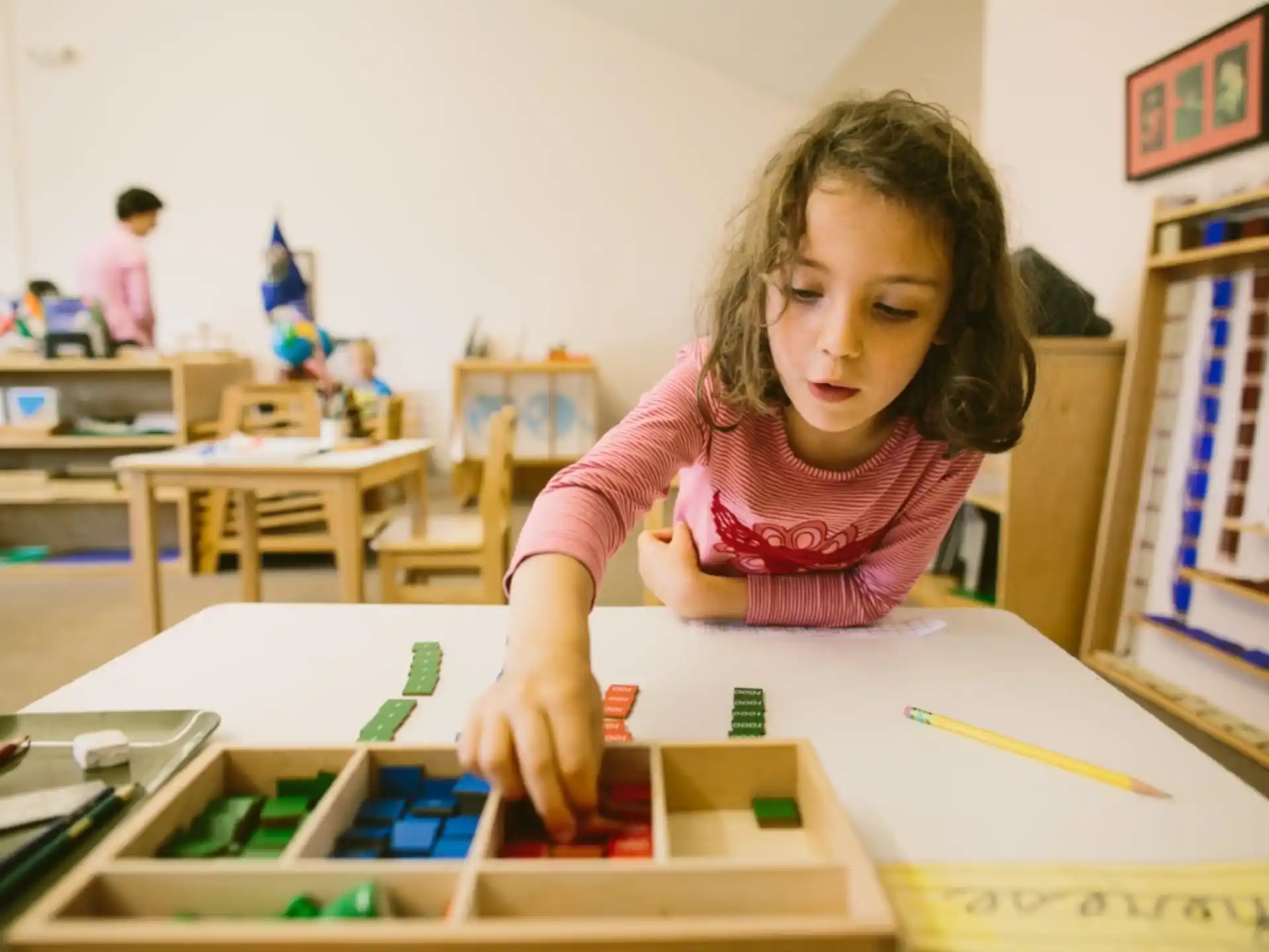 a young girl sitting at a desk