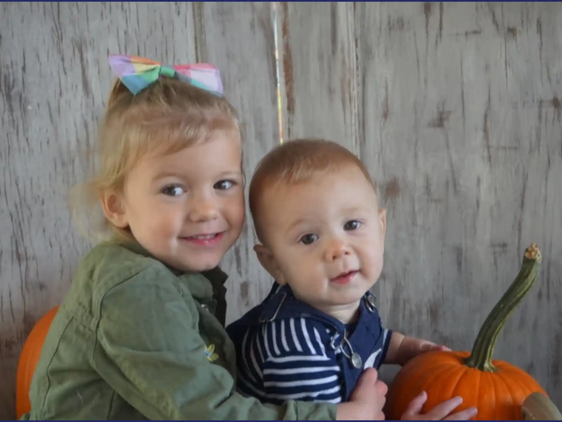 a couple of children posing for the camera