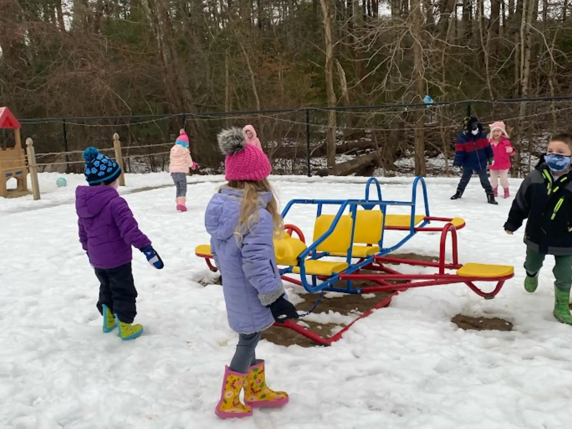 a group of people playing in the snow