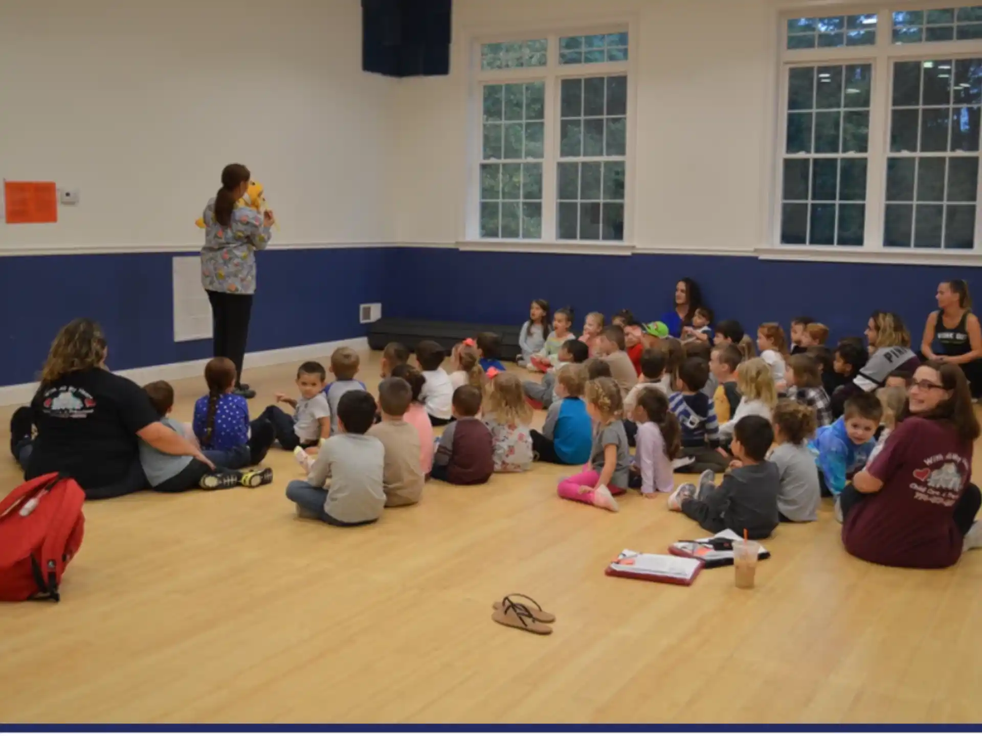 a group of people sitting on the floor in a room