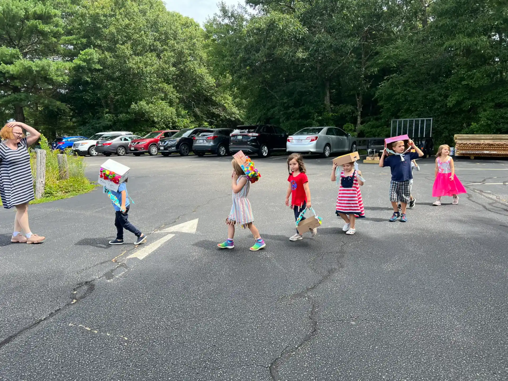 a group of children walking in a parking lot