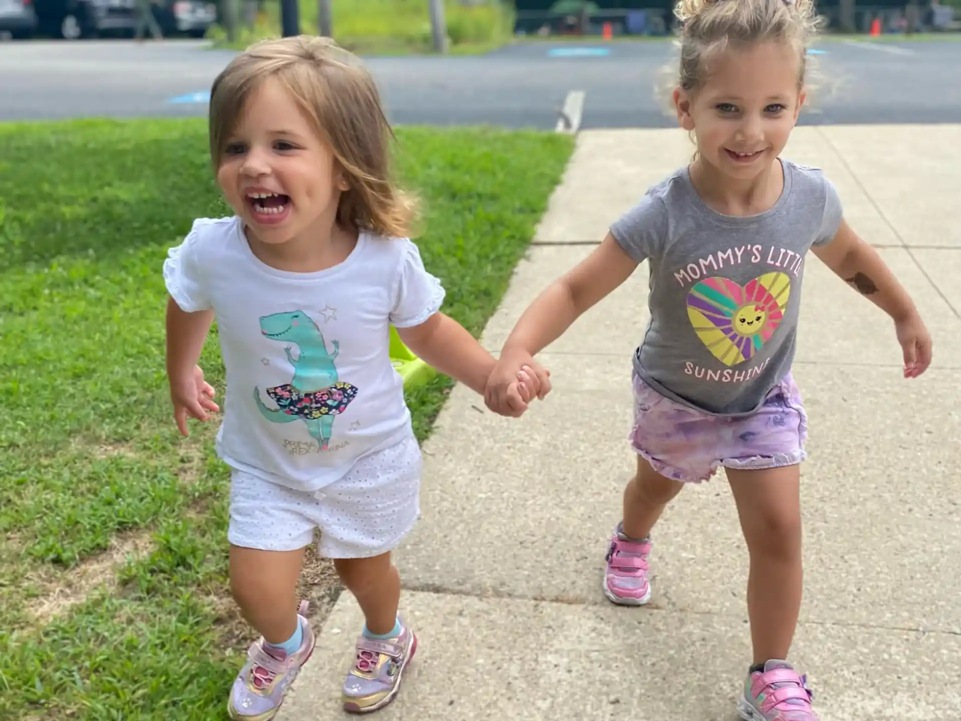 two girls running on a path