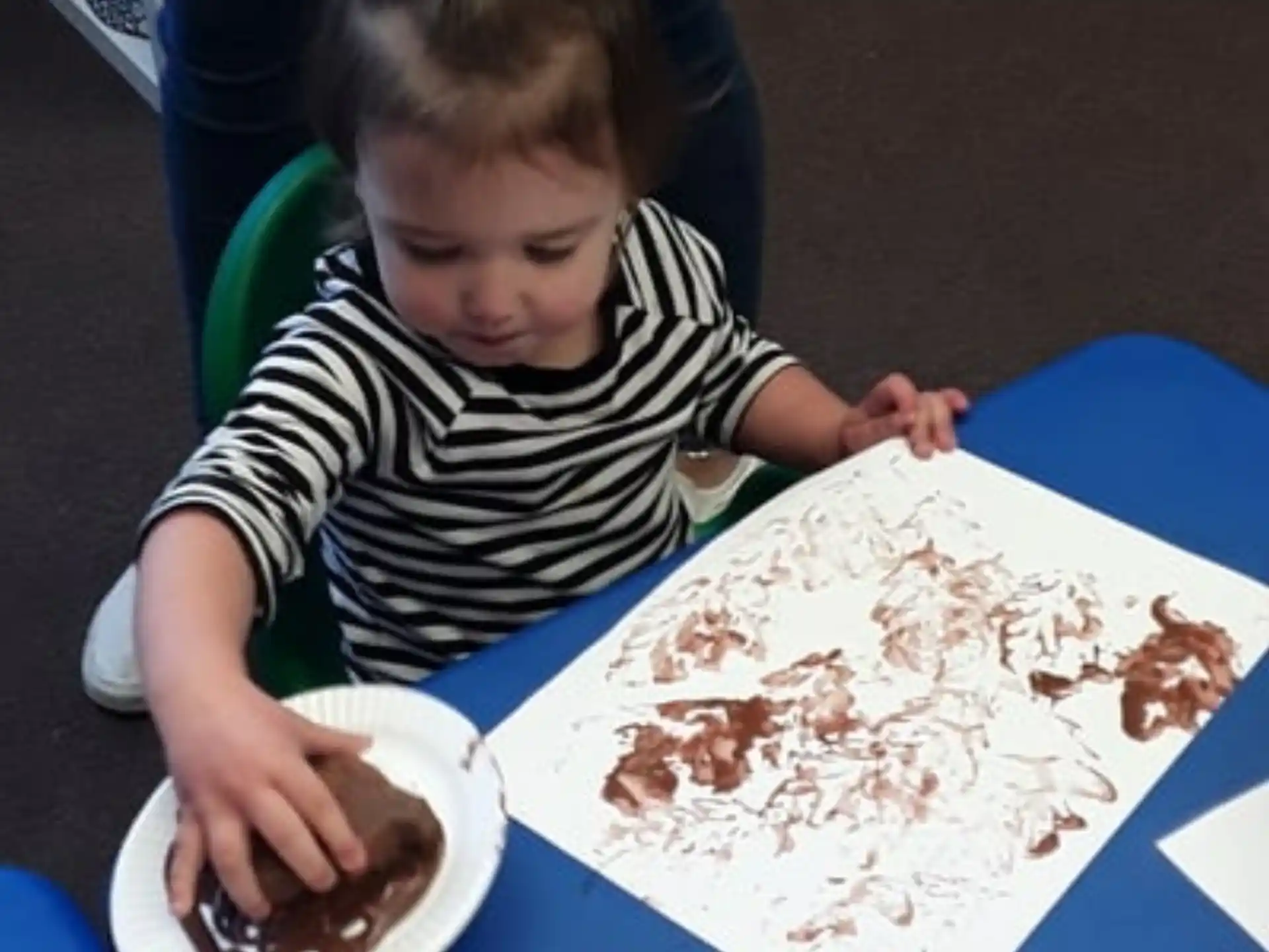a girl sitting at a table