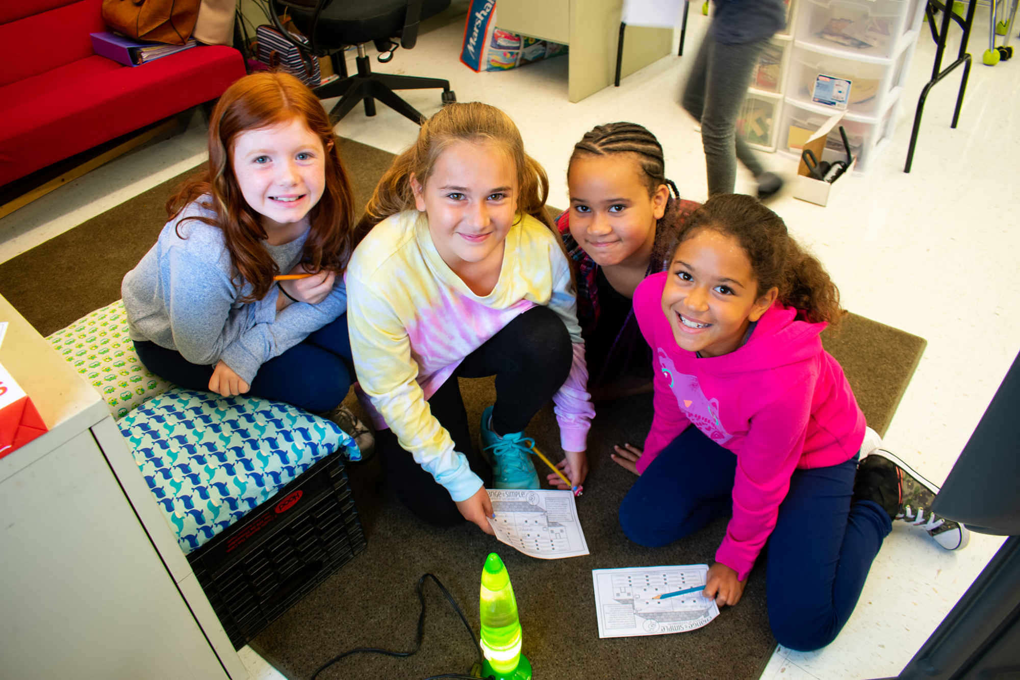 a group of girls sitting on the floor