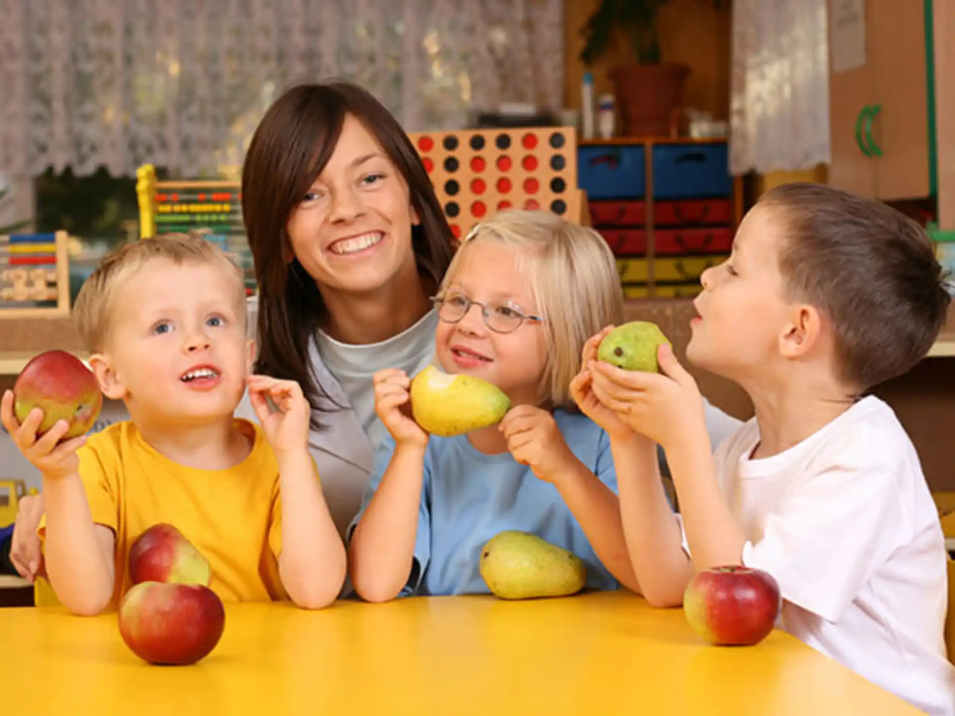 a person and several children eating apples
