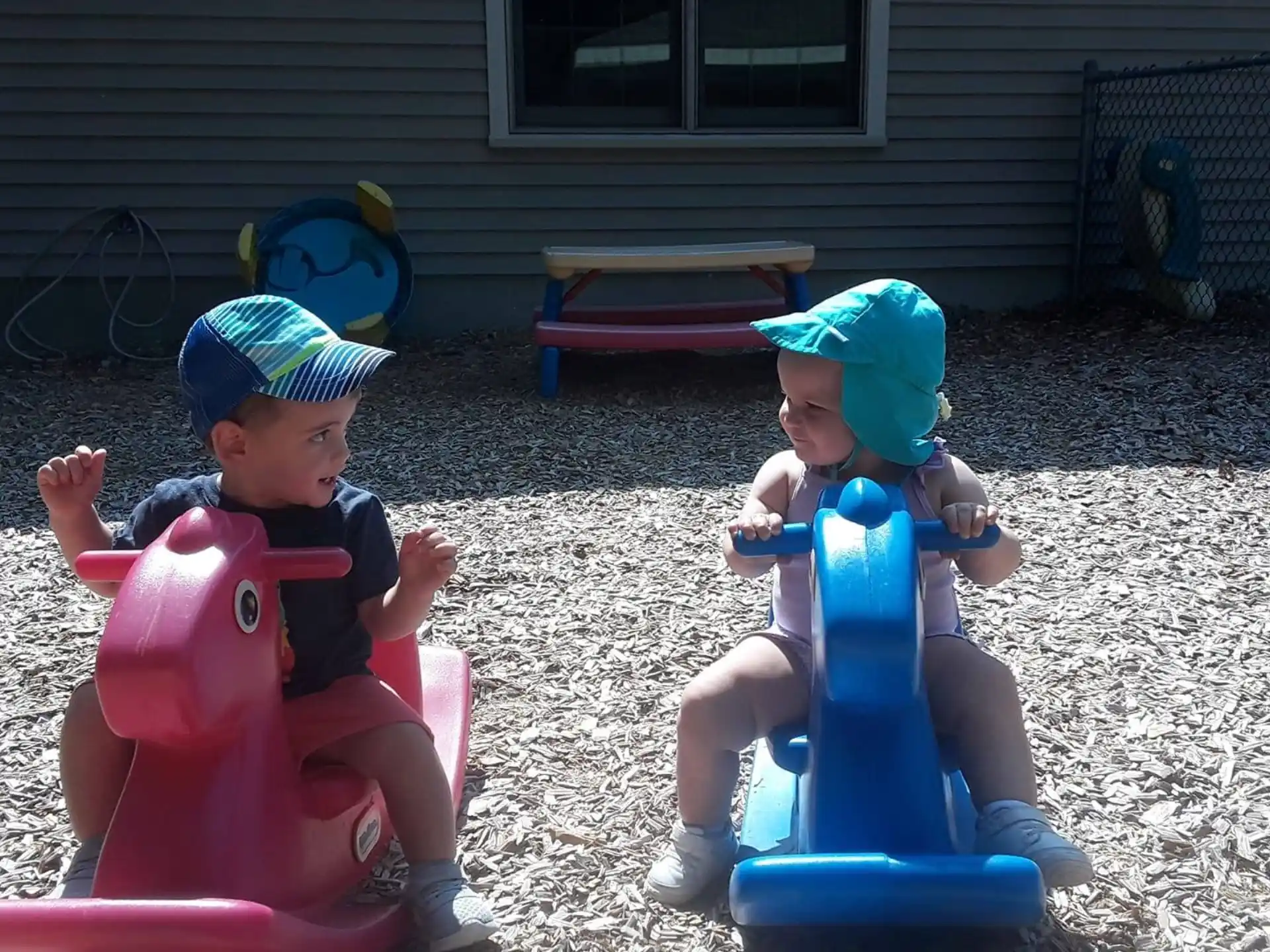two babies sitting on toy toys