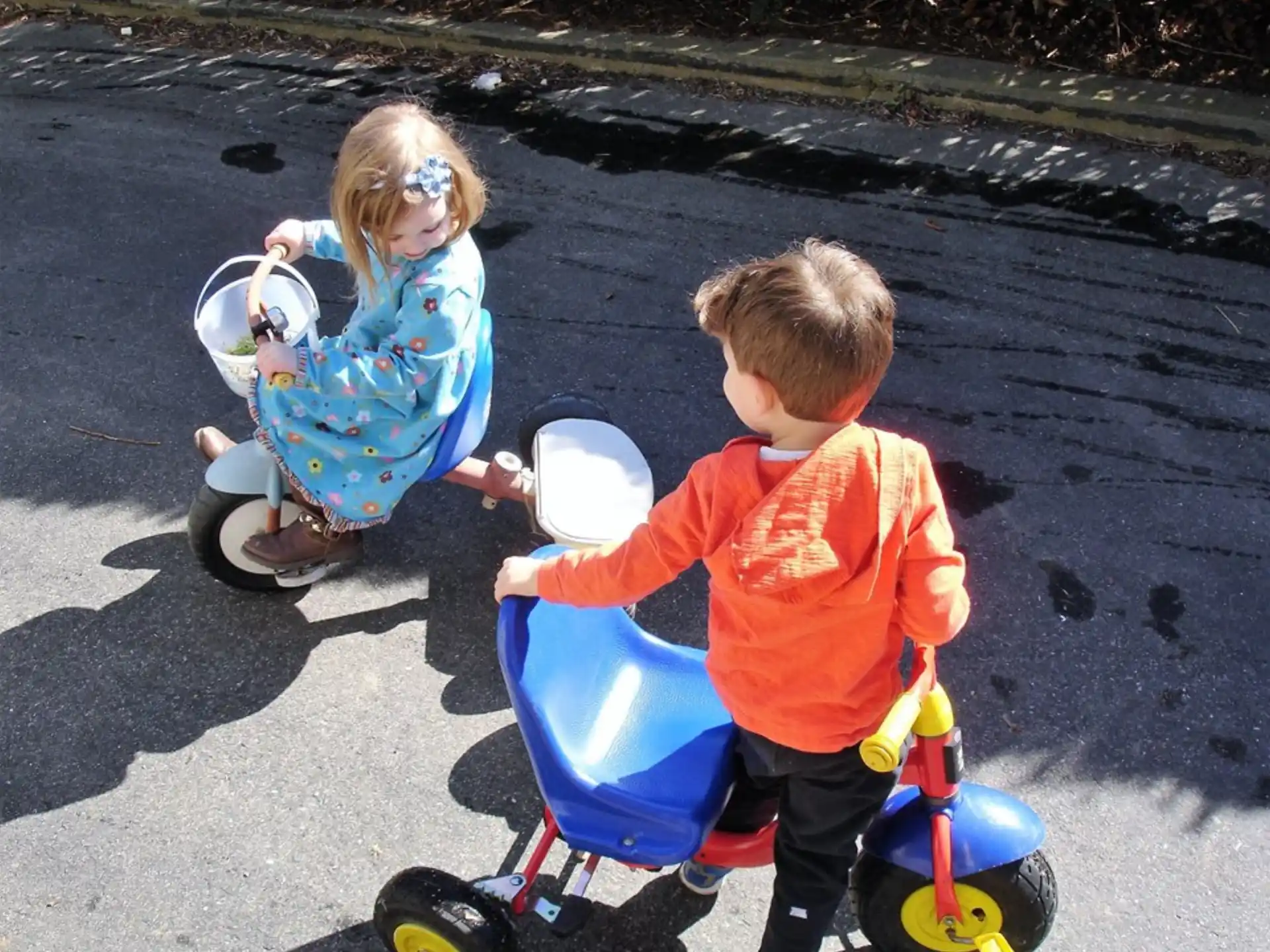 a couple of children riding toy bikes