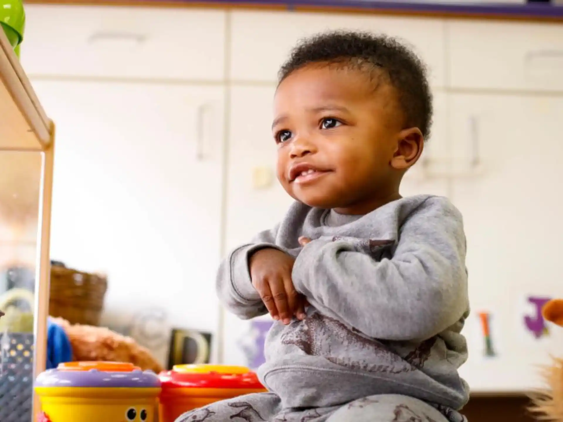 a baby in a gray sweater