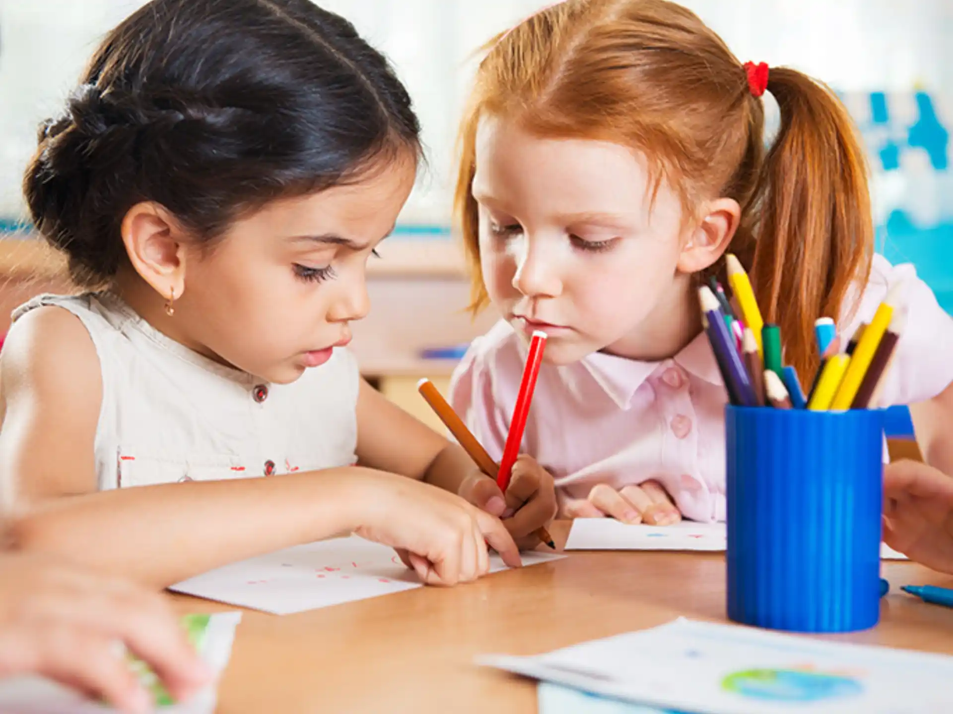 a few young girls coloring