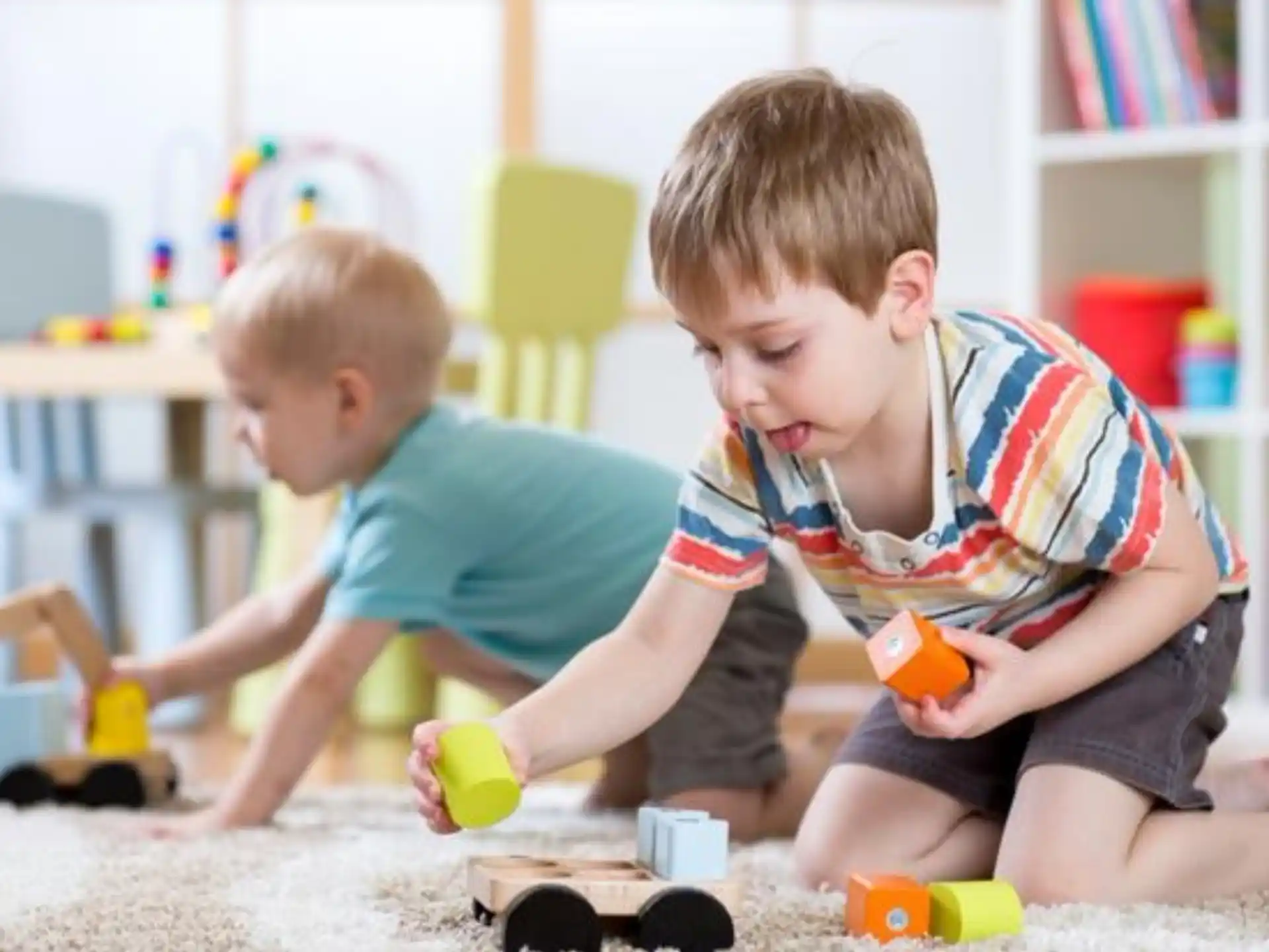 two boys playing with toys