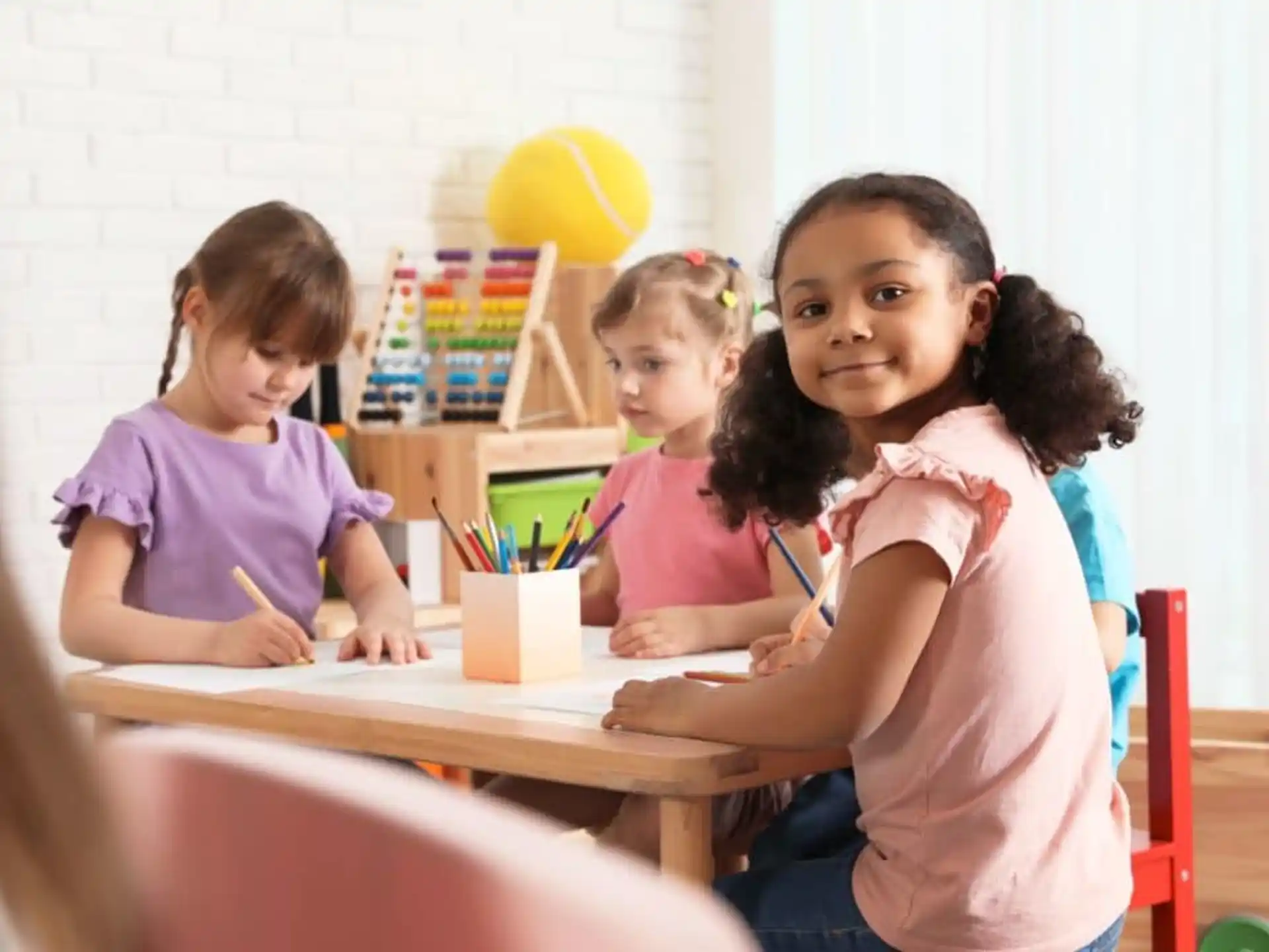 a group of children sitting at a table