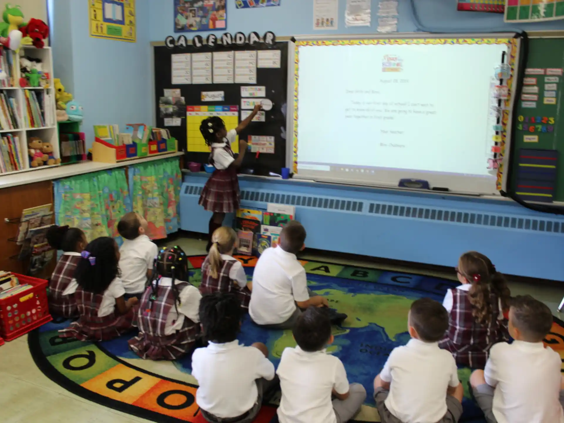 a group of children watching a presentation