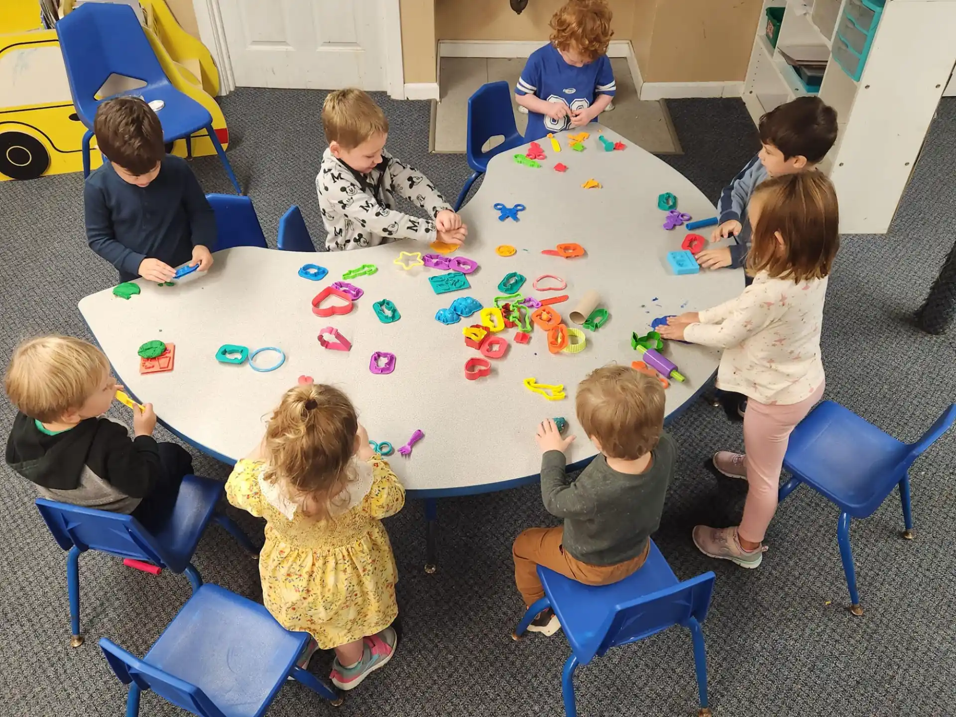 a group of children sitting around a table