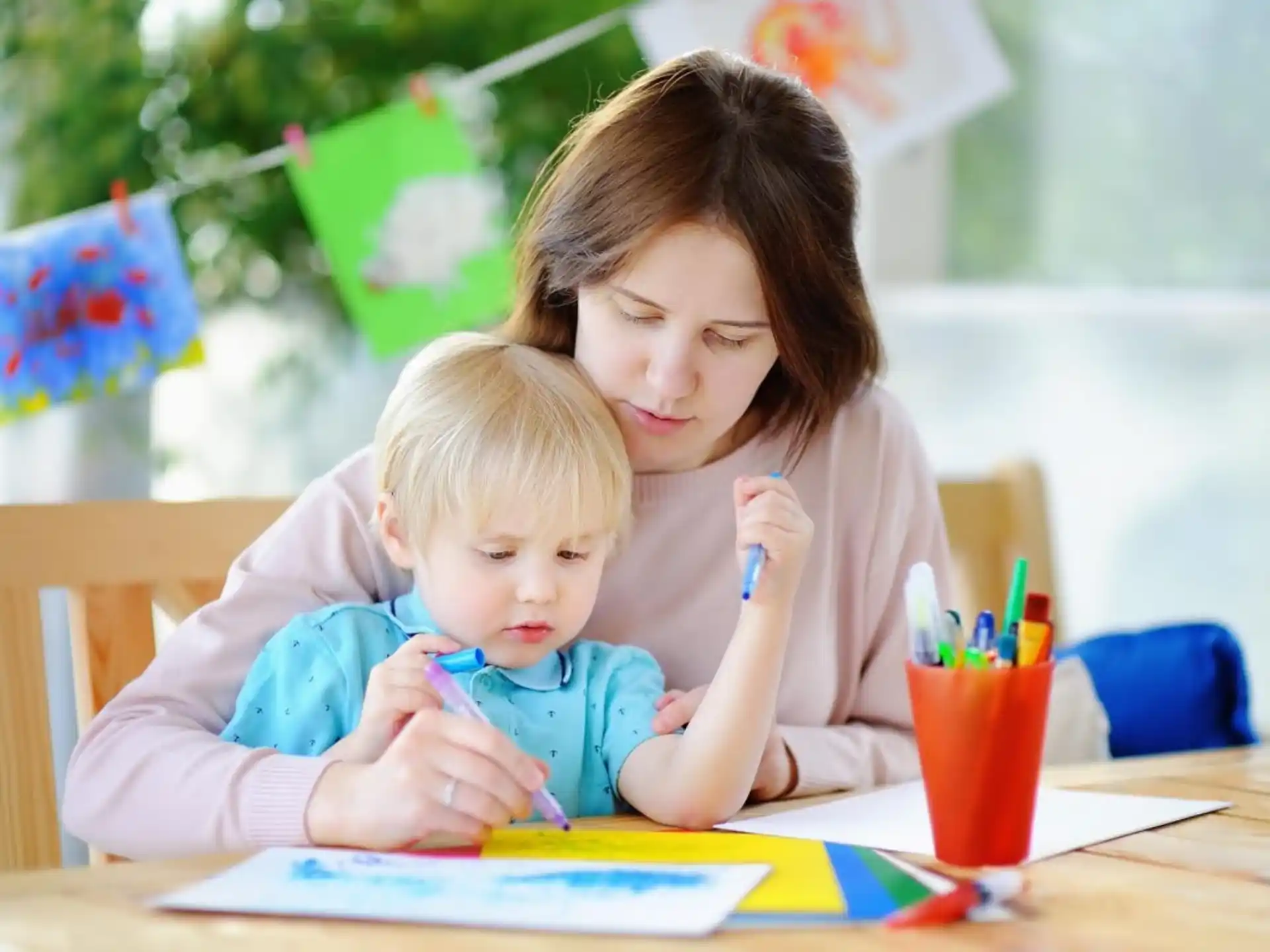 a person and a child sitting at a table
