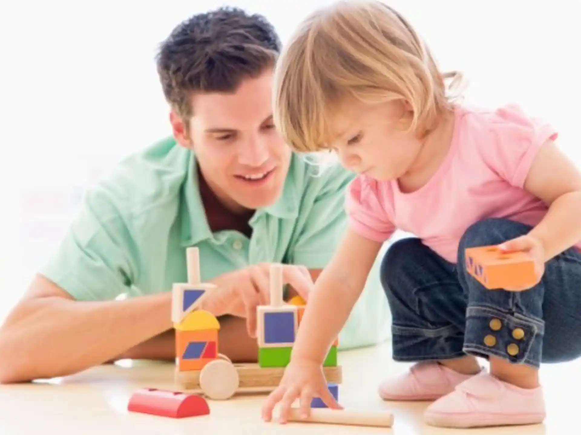 a boy and a girl playing with a toy