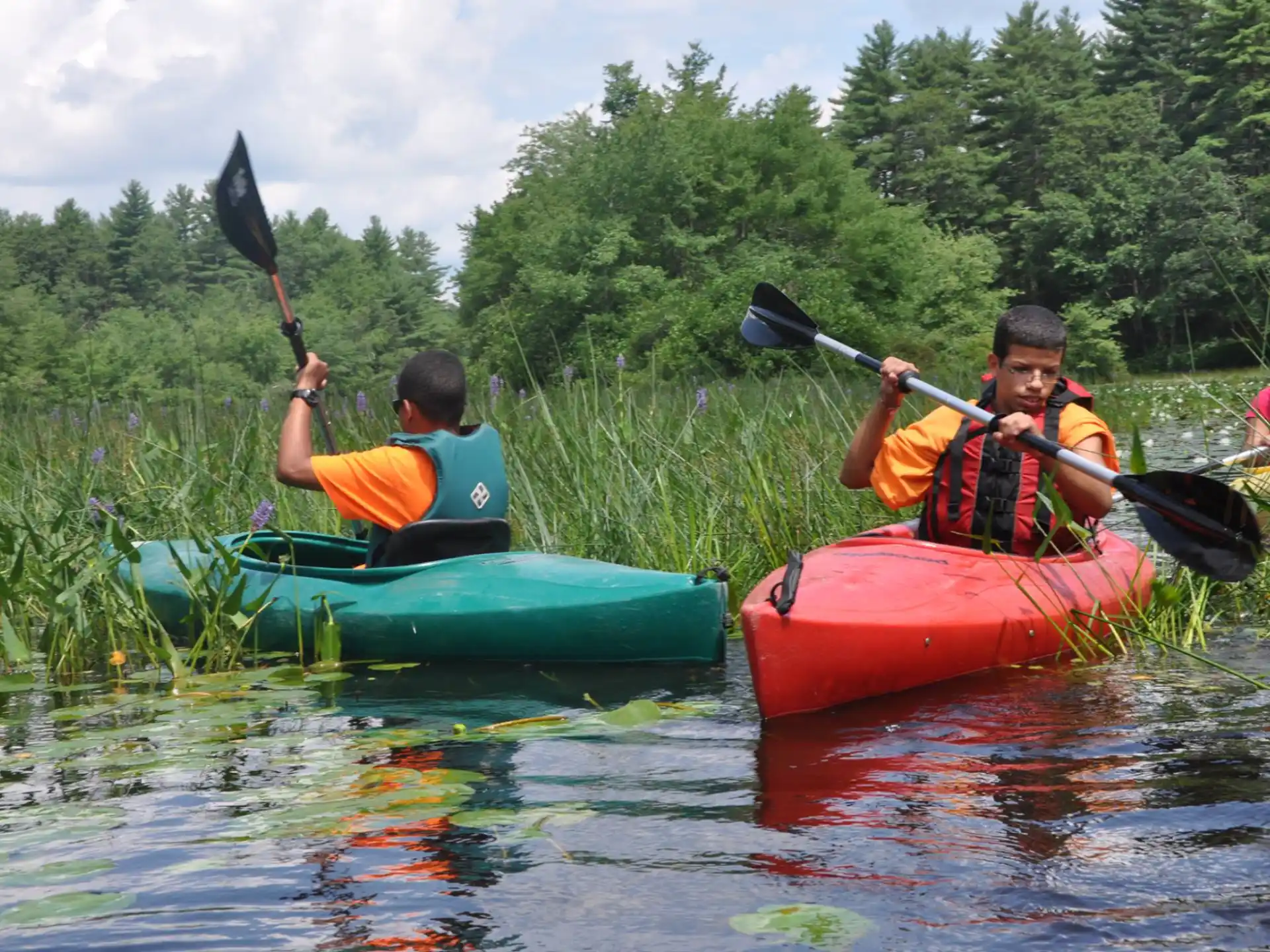 a group of people in kayaks on a river
