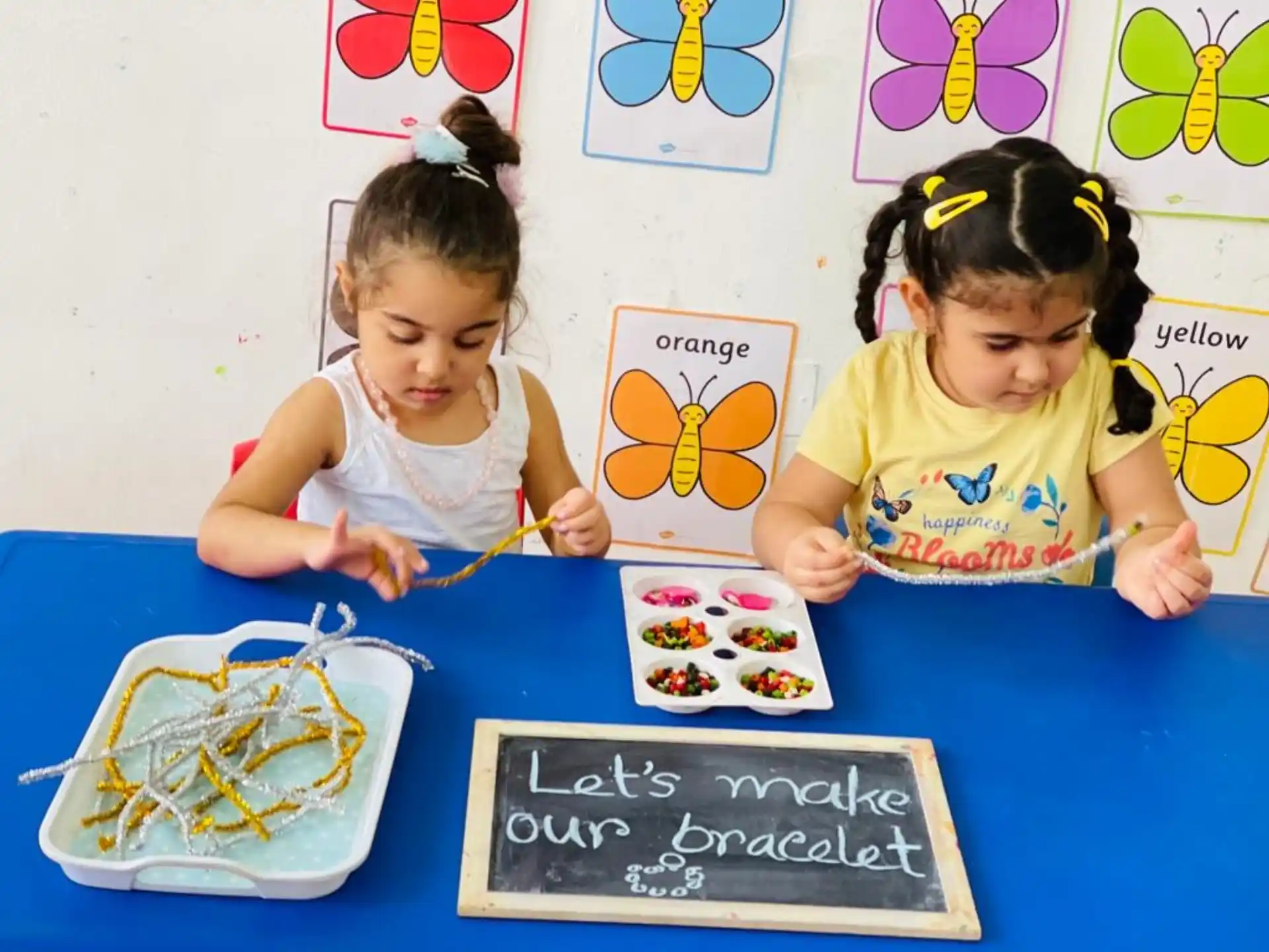 a couple of young girls playing with toys