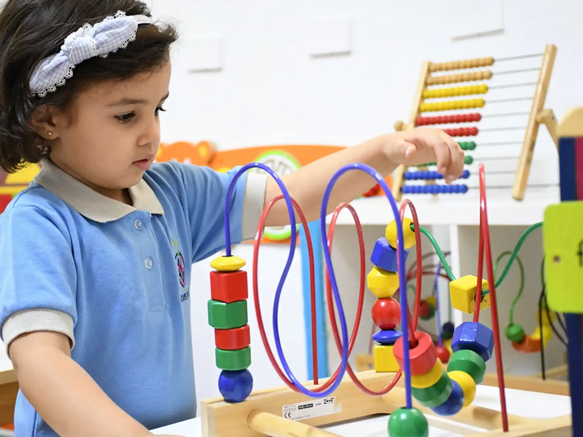 a young girl playing with a toy
