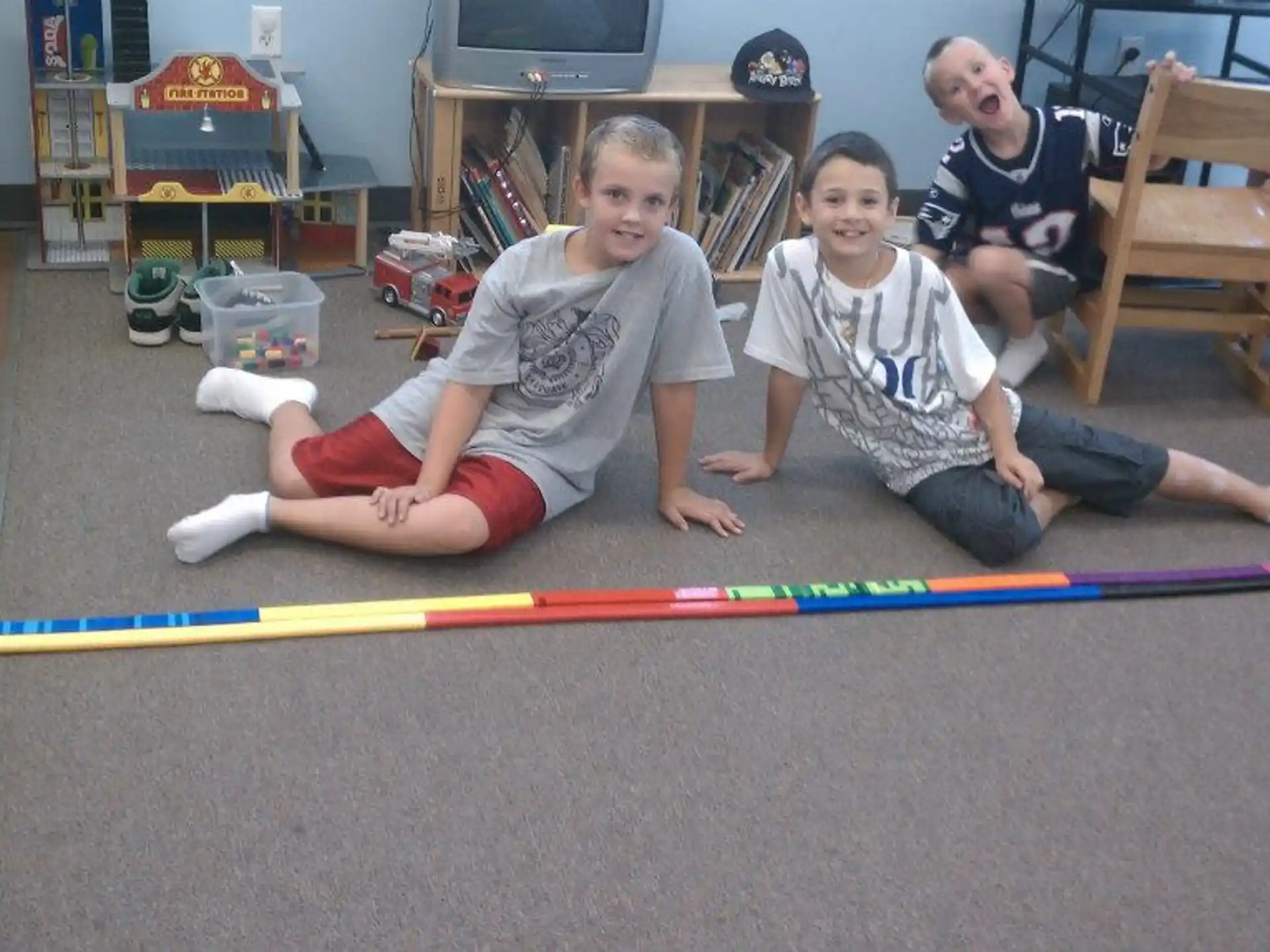 a couple of kids playing on the floor