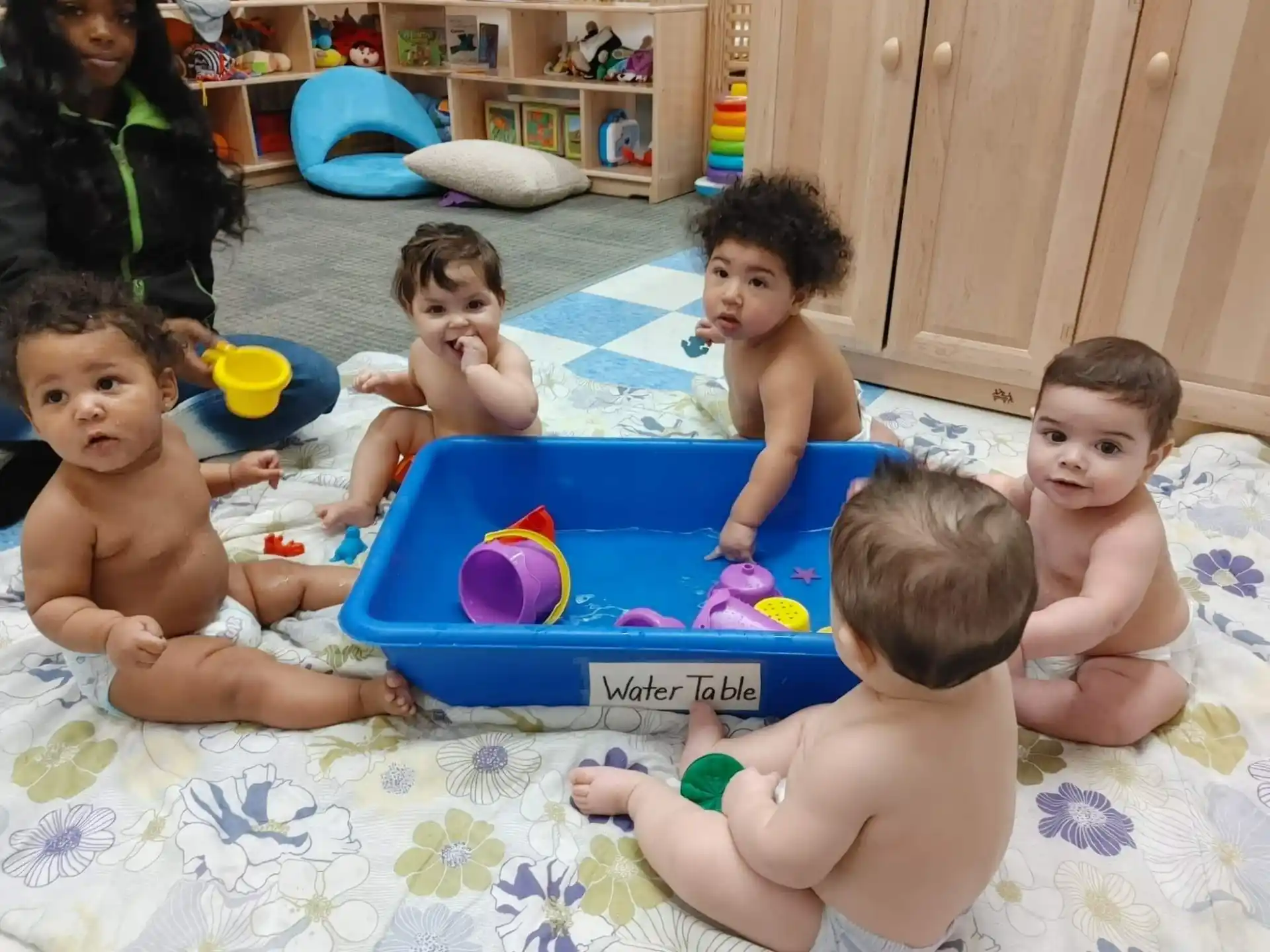 a group of kids playing in a pool