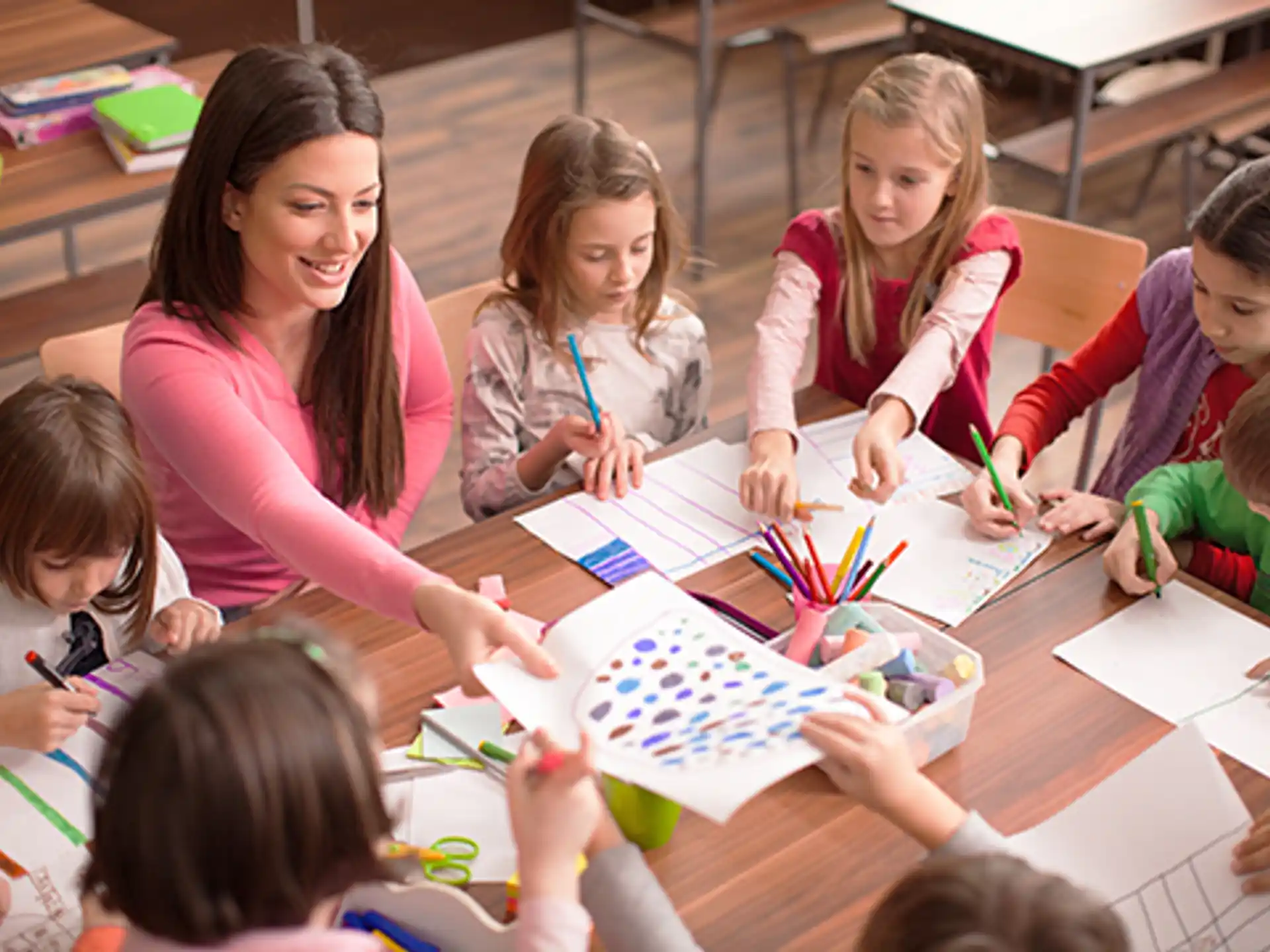 a group of children sitting at a table