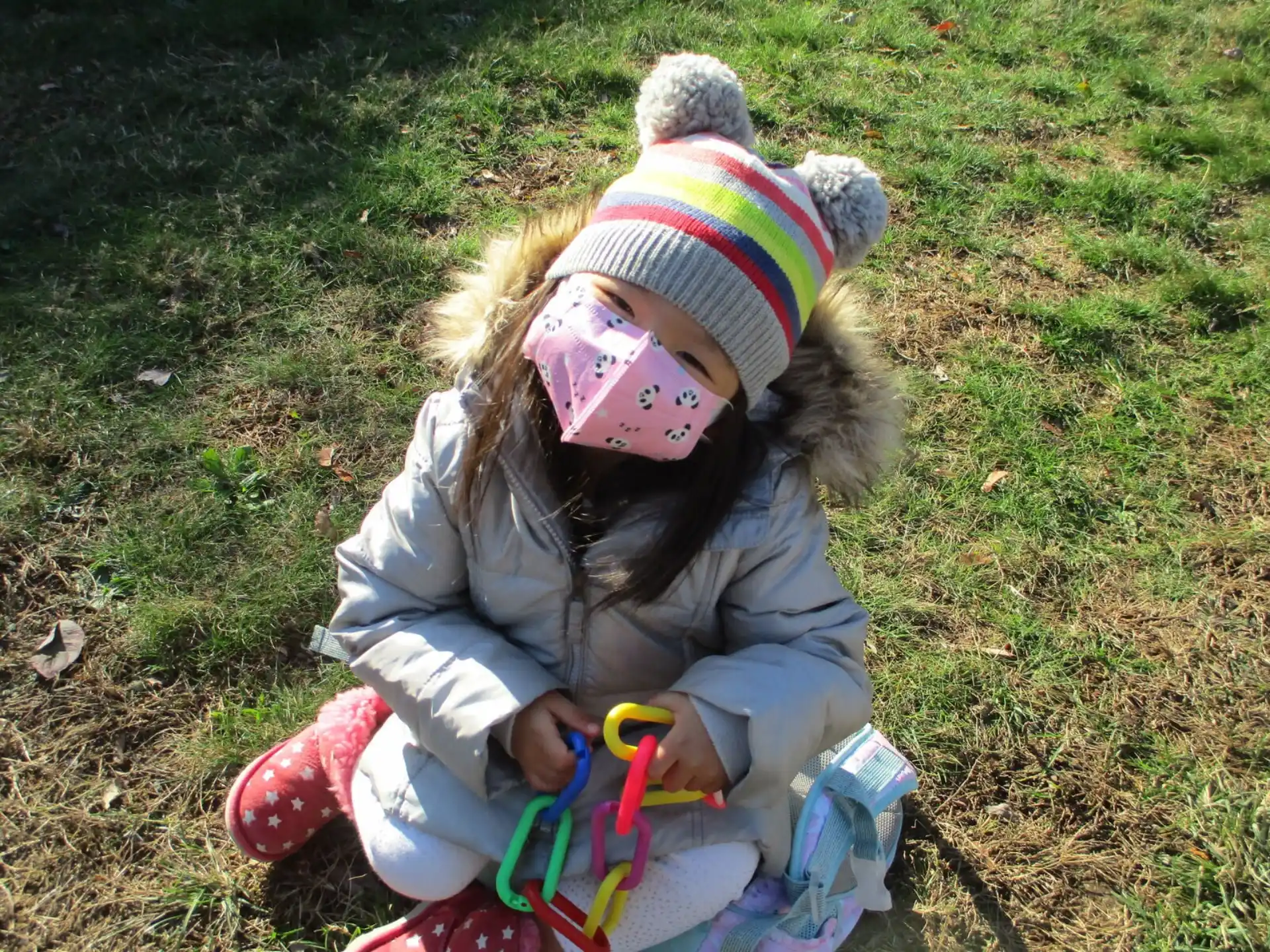 a baby sitting on the grass