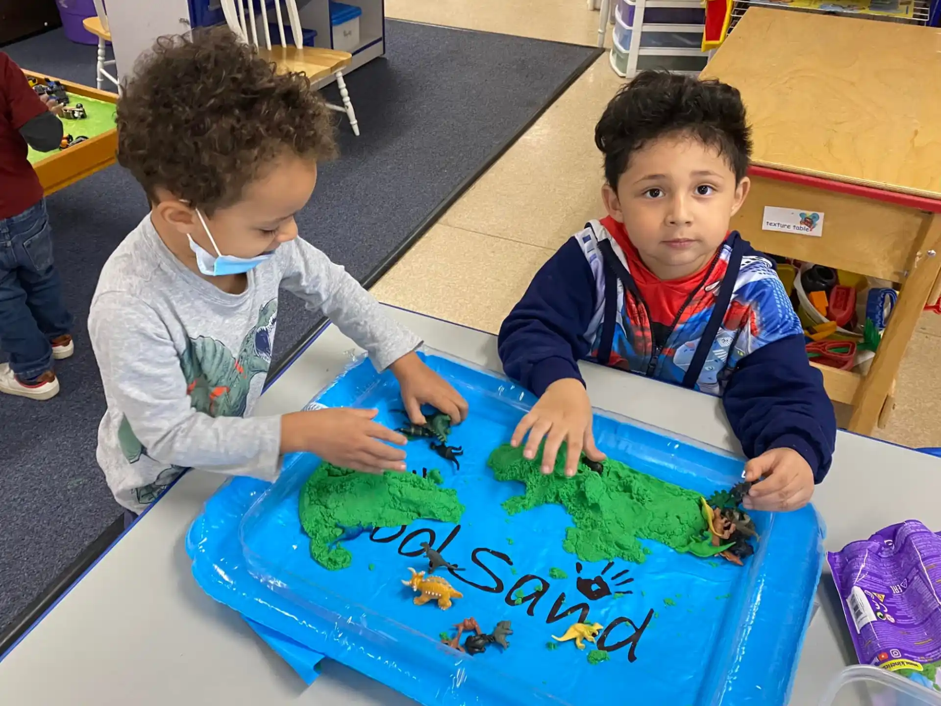 a couple of boys playing with a toy