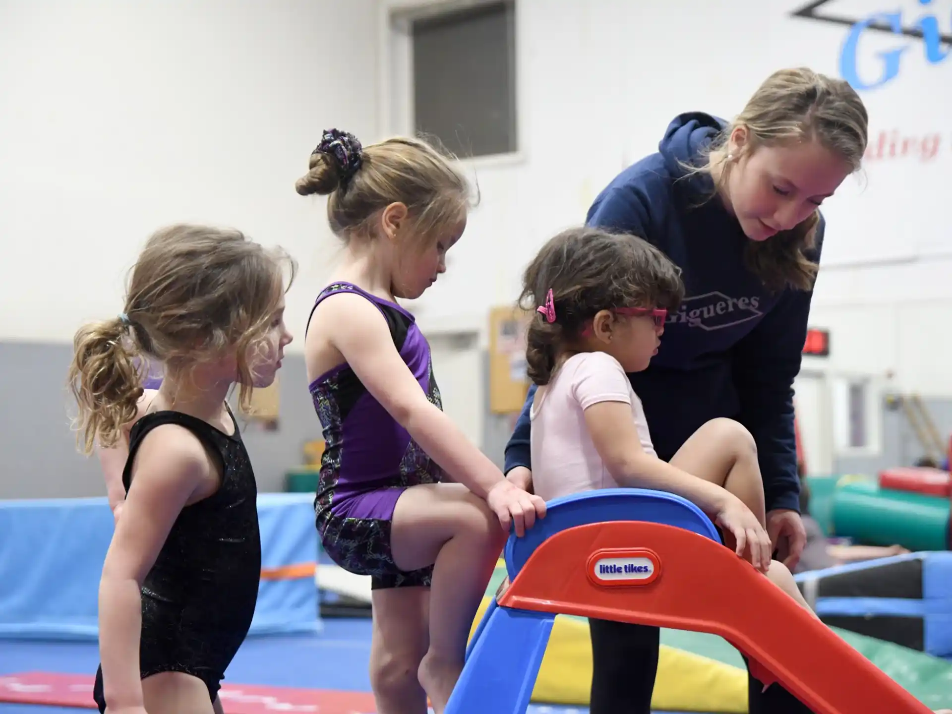 a group of girls playing on a trampoline
