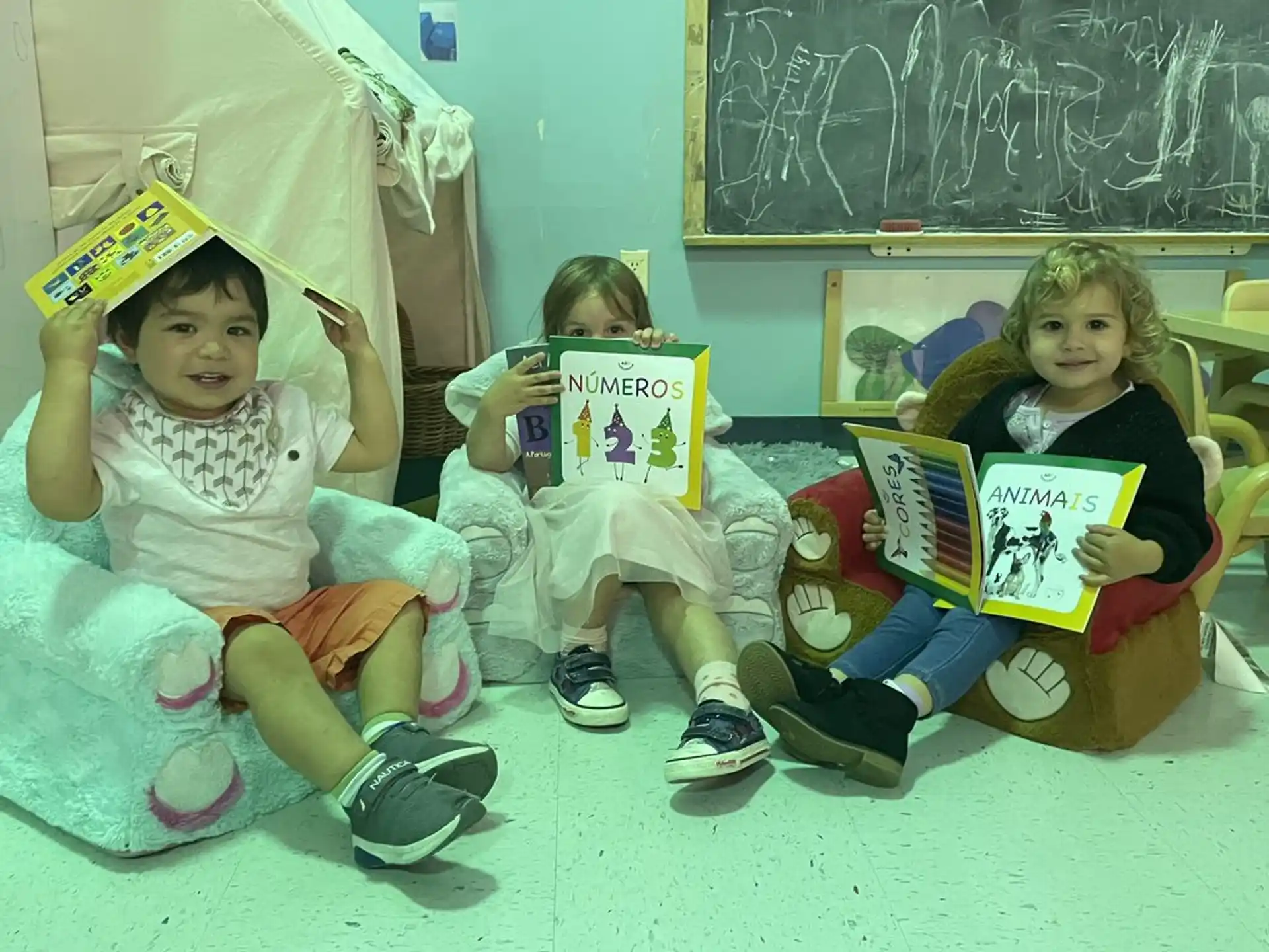 a group of children holding books