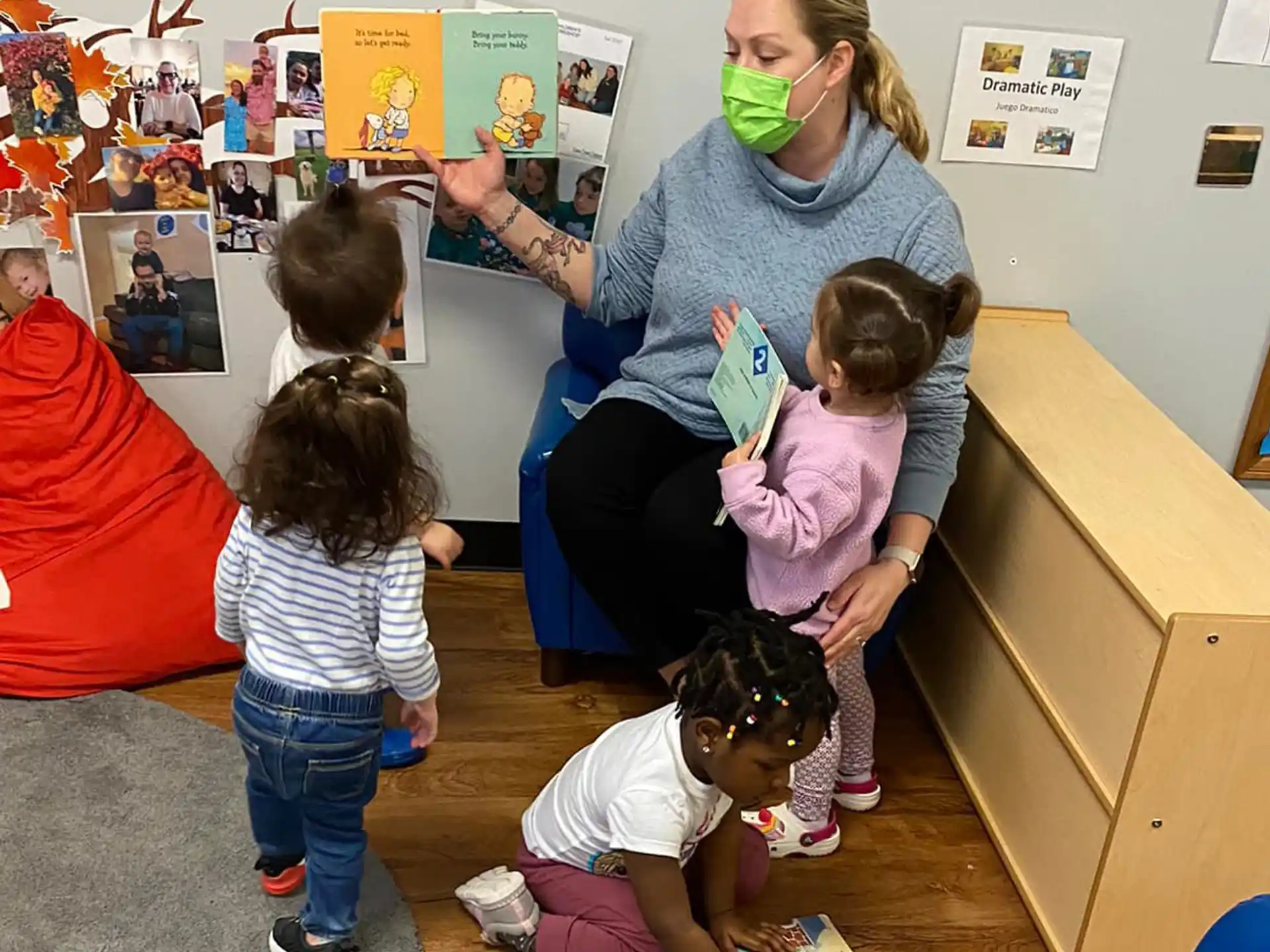 a person and several children in a classroom