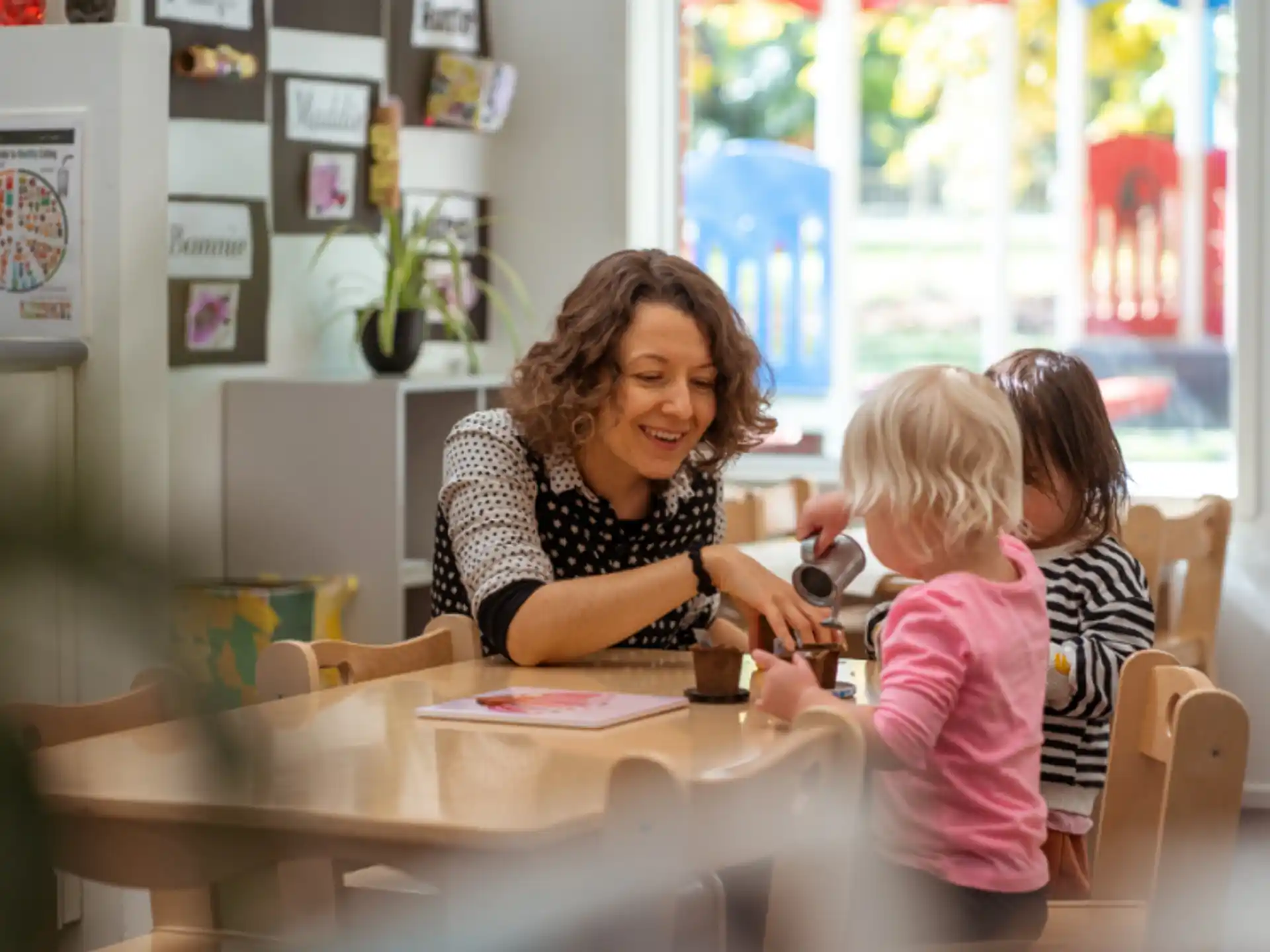 a person and two children sitting at a table