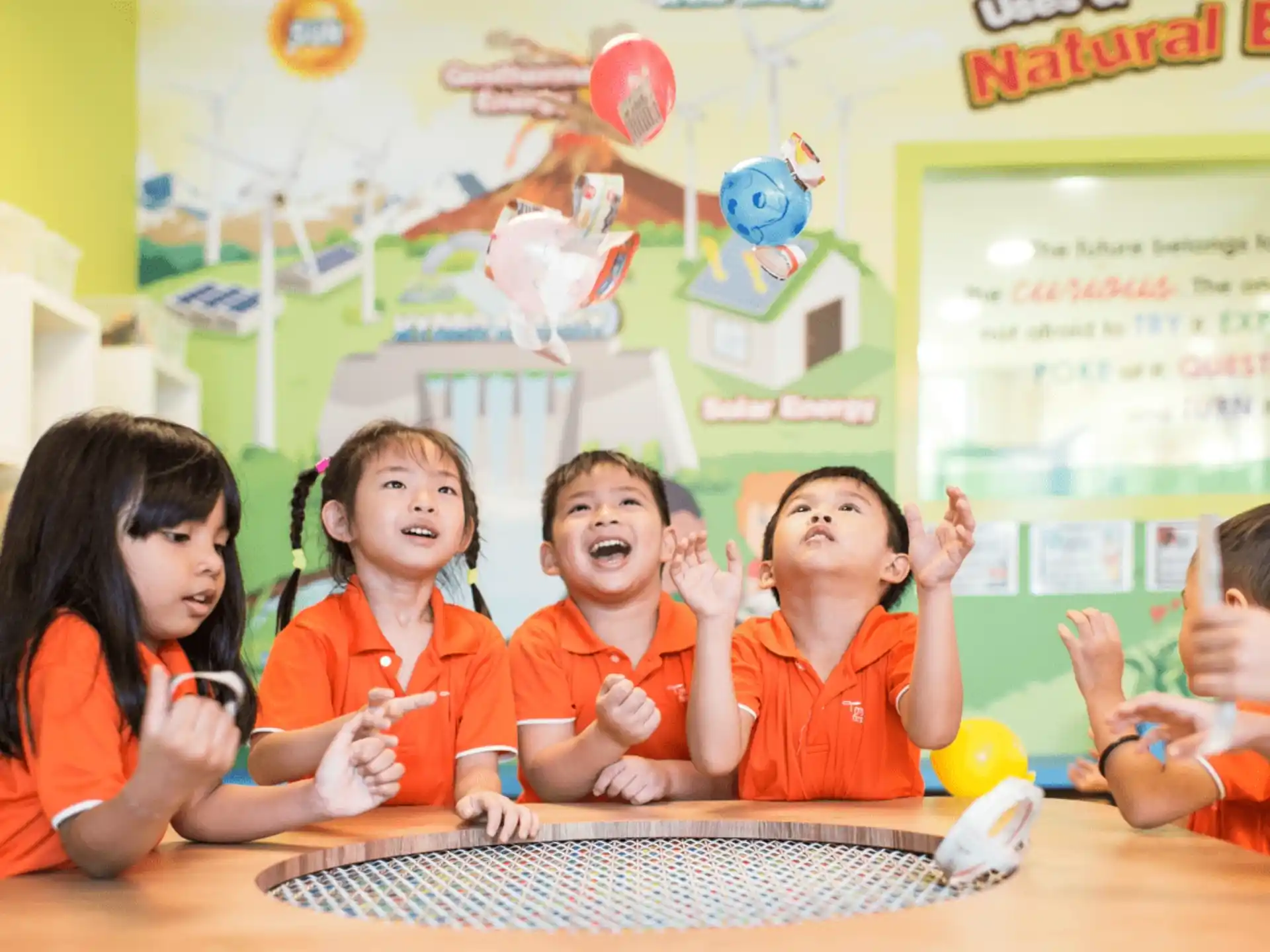 a group of children in orange t-shirts