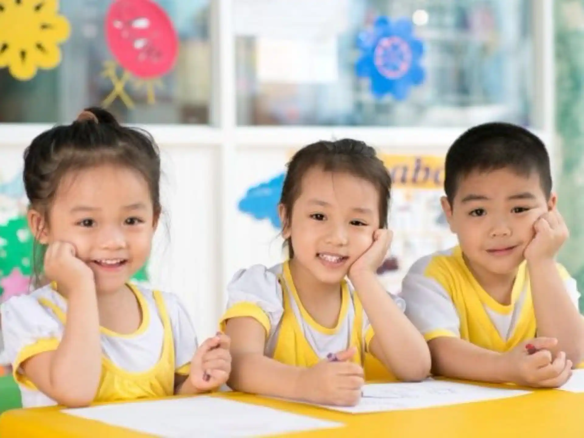 a group of children sitting at a table