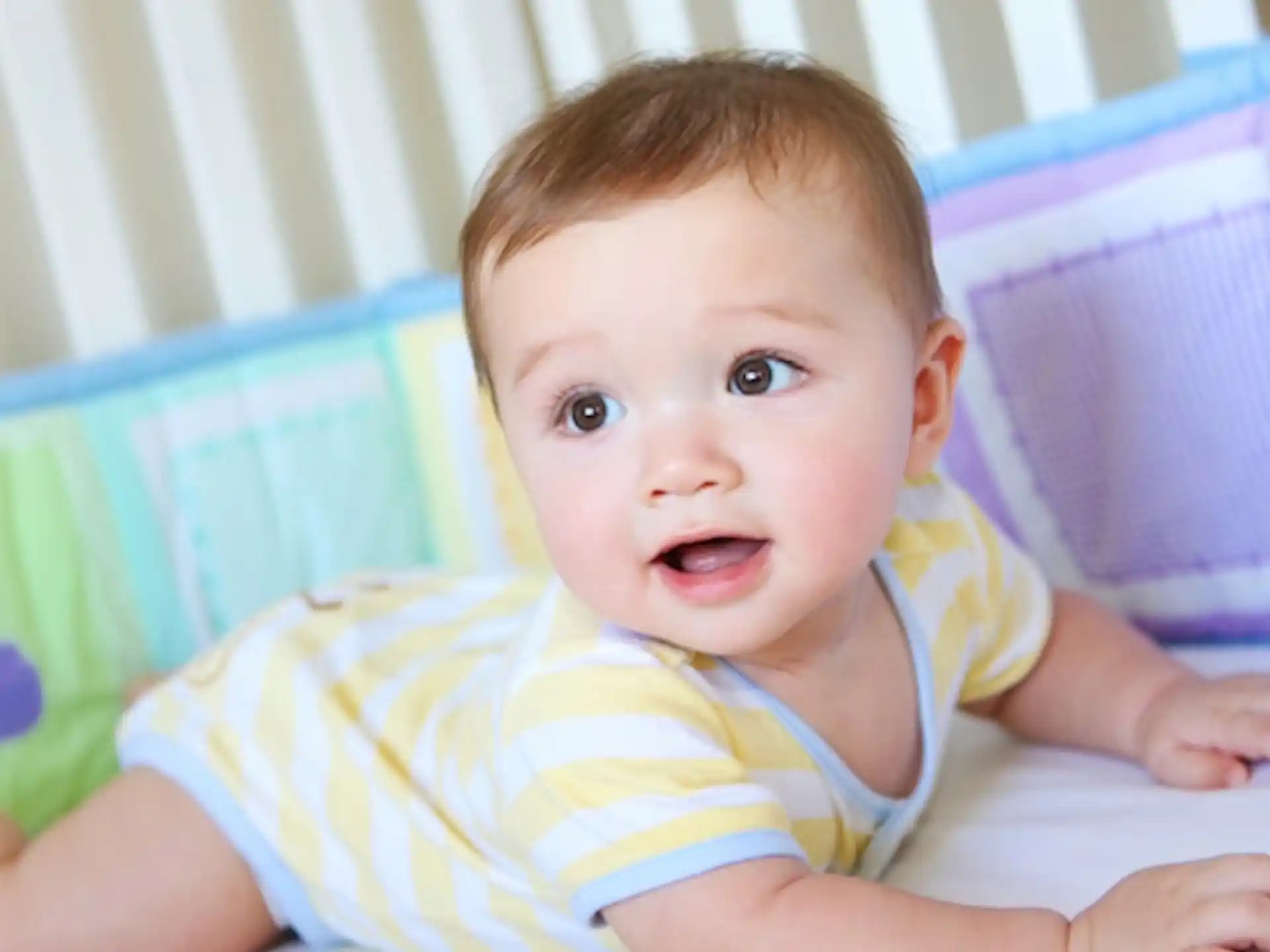 a baby lying on a bed