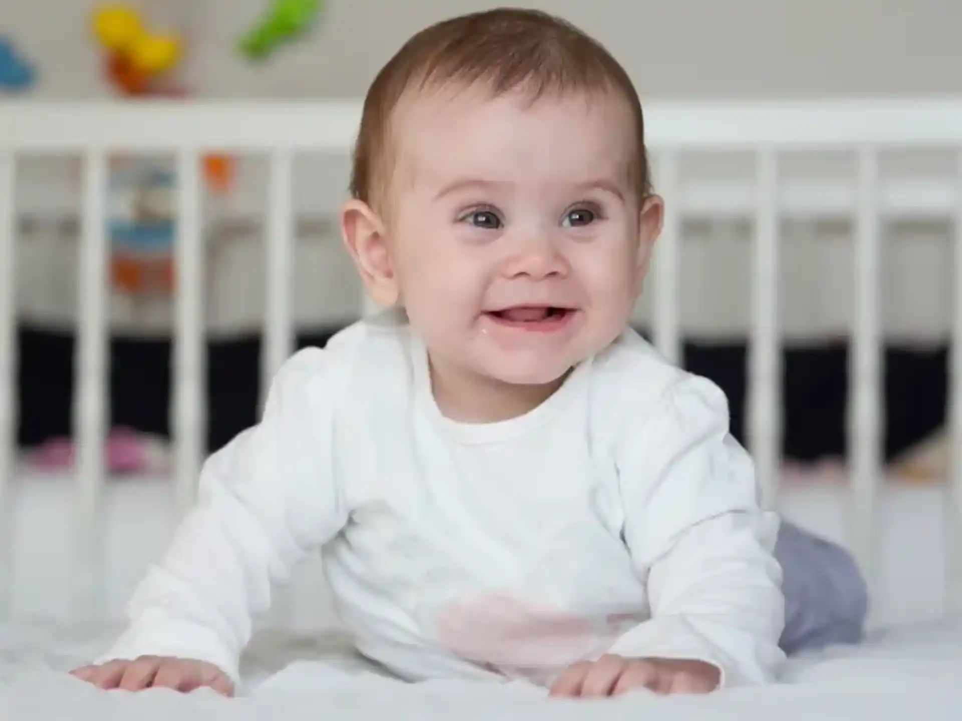a baby lying on a bed