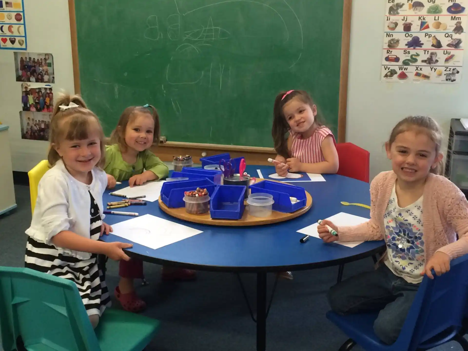 a group of children sitting around a table