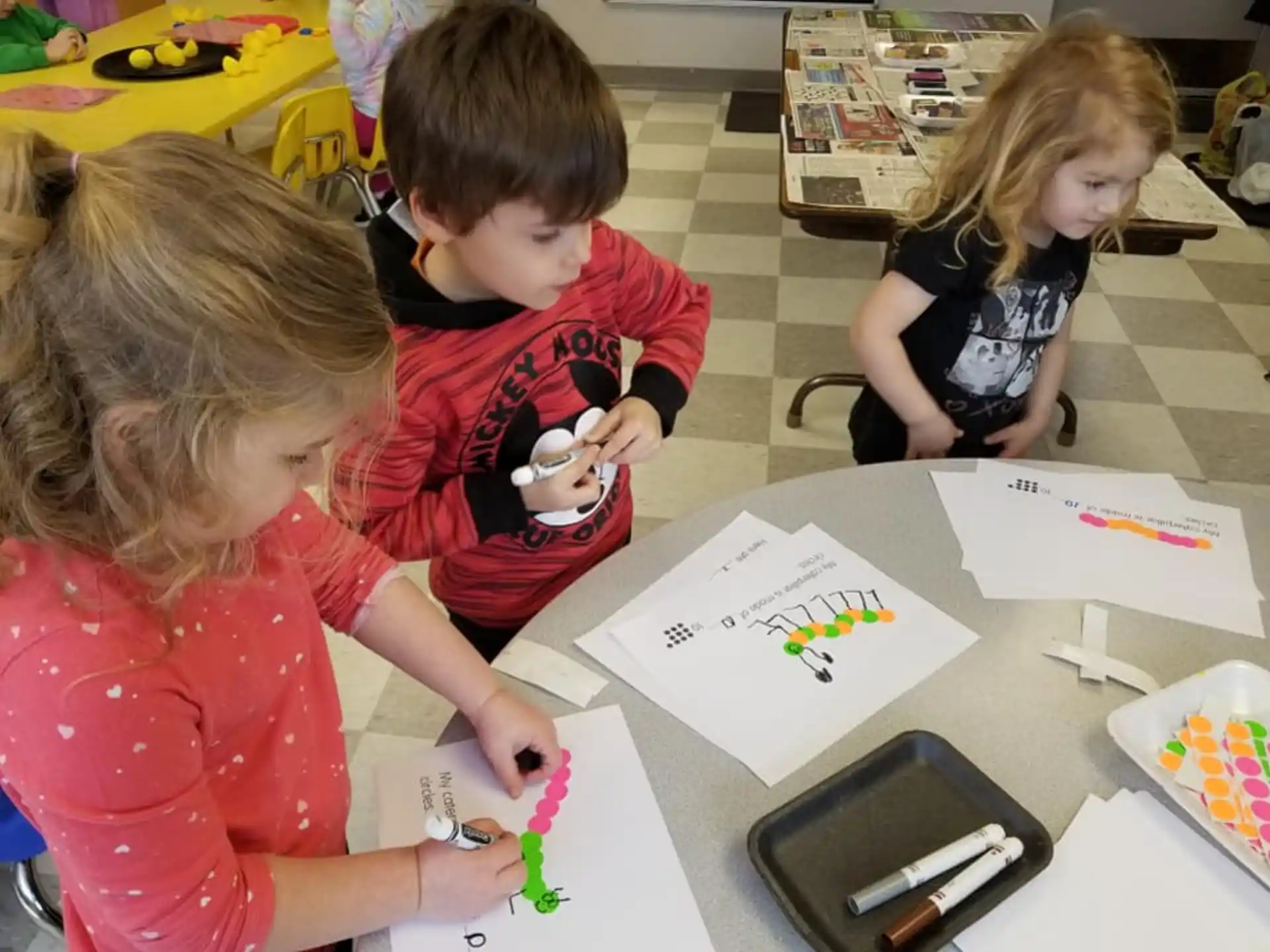 a group of children sitting at a table