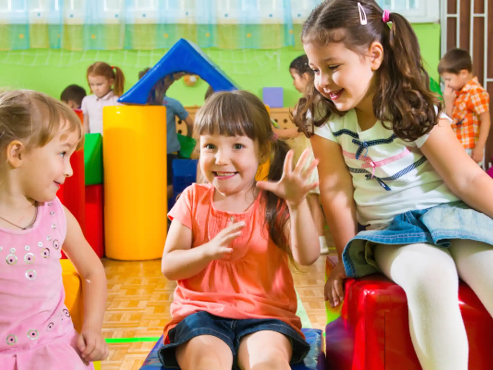 a group of children sitting on a play set