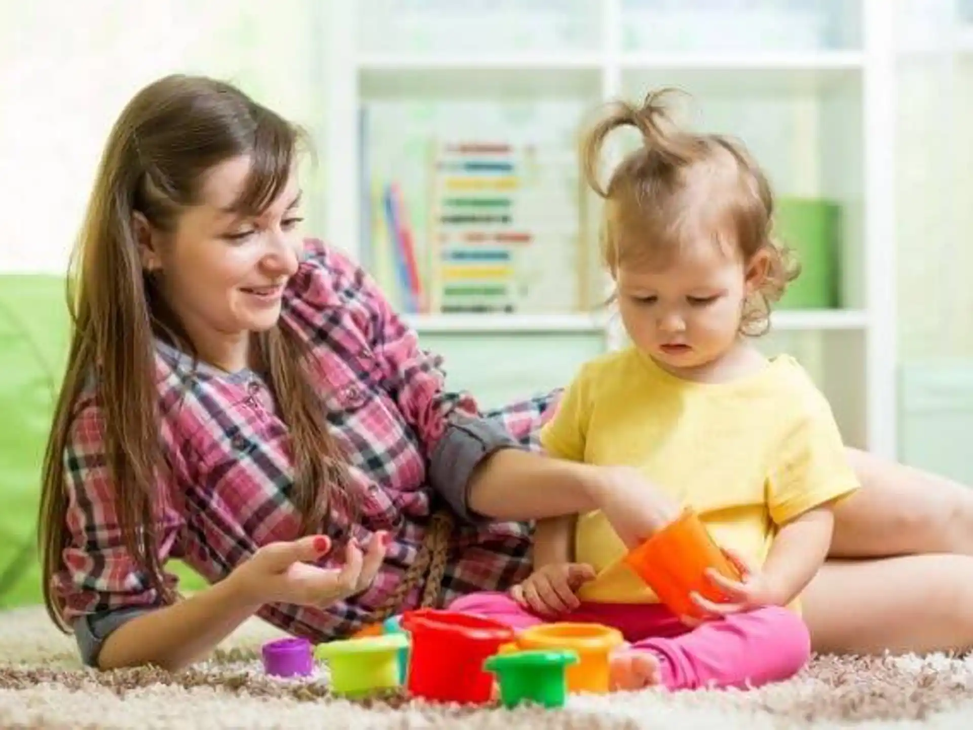 a person and a child playing with toys